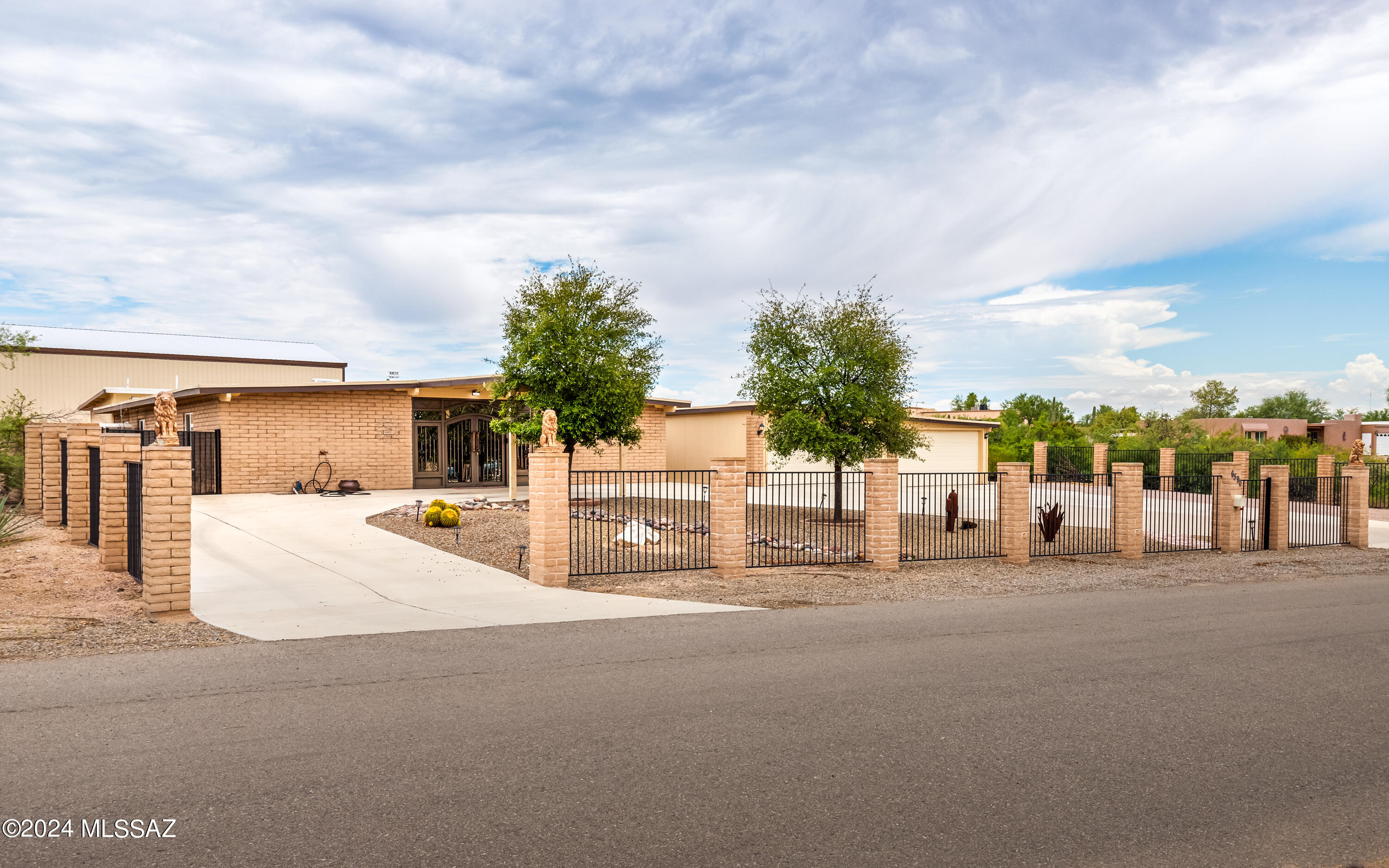 Beautiful Iron Doors to the Entrance of the Open Foyer. Gorgeous Home with 4 Bedrooms, 4 Bathrooms, 2 Master Suites. Rec Room with Sliding Door to Outside Covered Patio, Outdoor Kitchen with Built-In BBQ and Sink. Sparkling Pool and Spa in Large Open Backyard. 40x60 Metal Out Building with 17' Ceiling. Oversized 4 Car Garage and Carport with Circular Driveway. This home has it all!