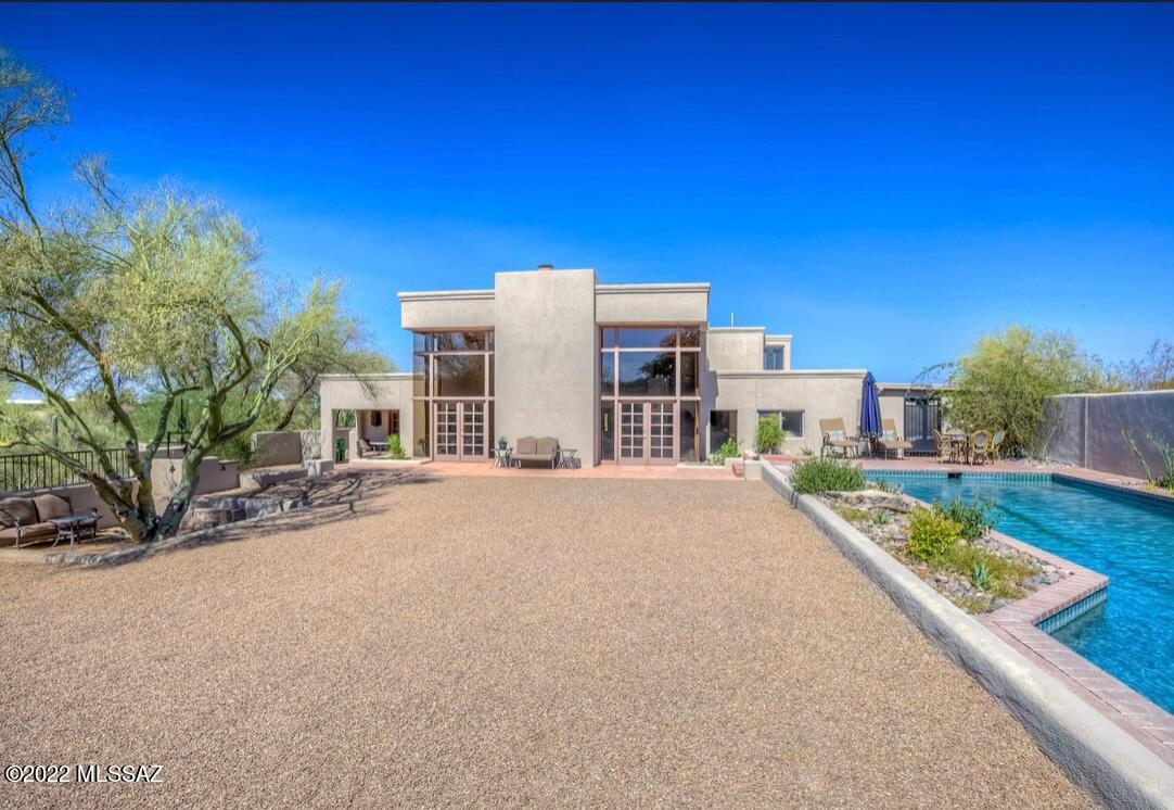 Unique, custom-built home located in a secluded neighborhood within the heart of Catalina Foothills. 4bds/3bths, Great room 29'Lx24'Wx17'H with floor-to-ceiling windows. New quartz counters & matching brass fixtures throughout. Extra-large kitchen with double oven, abundant cabinet space, stainless appliances, island cooktop/vent hood, gold stainless sink, & walk in pantry. Loft & Primary bedroom on second-floor w/sitting area, jetted tub & shower, large walk-in closet. Balcony staircase to roof w/sitting deck & 360° majestic views. 3 fireplaces, wet bar in study. 2nd bed can be 2nd Primary or Guest Quarters w/private entry & bath. Rooms 3 & 4 connect w/Jack & Jill bath. Lap Pool w/waterfall & grotto. 2 car garage, carport, & plenty of room for parking. Not subject to the Flecha Caida HOA