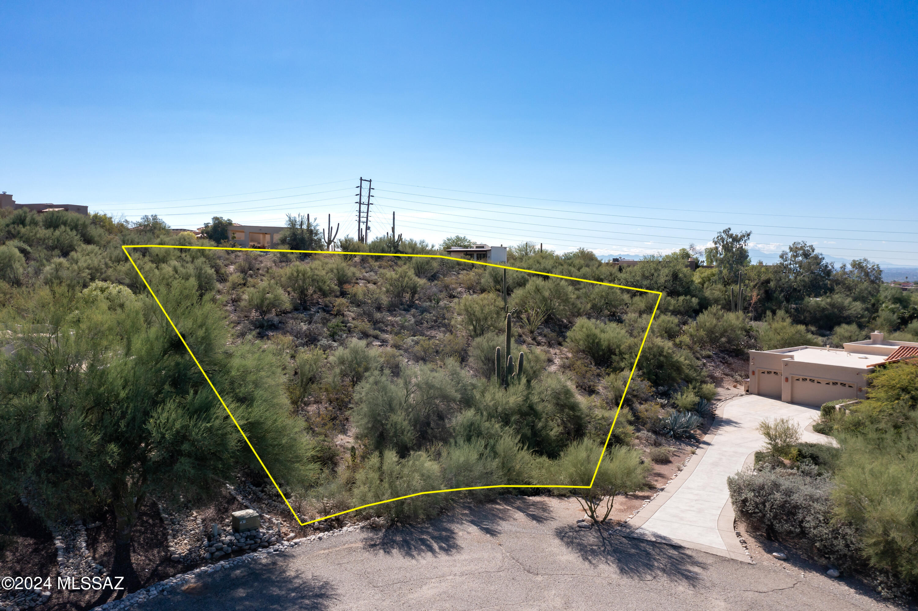 Beautiful lot located in the CATALINA FOOTHILLS. This breathtaking lot sits inside a CUL-DE-SAC on a near acre CORNER LOT. Build your dream home here and enjoy the LUSH VEGETATION and the serene MOUNTAIN & CITY VIEWS that Tucson has to offer. The lush vegetation includes mature saguaros. This property is located in the Catalina Foothills School District. Just South of Sin Vacas Community. Lot also includes 30,000 dollar architectural plans as well as a survey. The plan plan is for a mid century modern contemporary home with 5 bedrooms, 4 bathrooms and 4.5 car garage. Come build your dream home on this spacious size lot. Just a few minutes from La Encantada Mall, country clubs and a variety of restaurants. This lot is something dreams are made of.