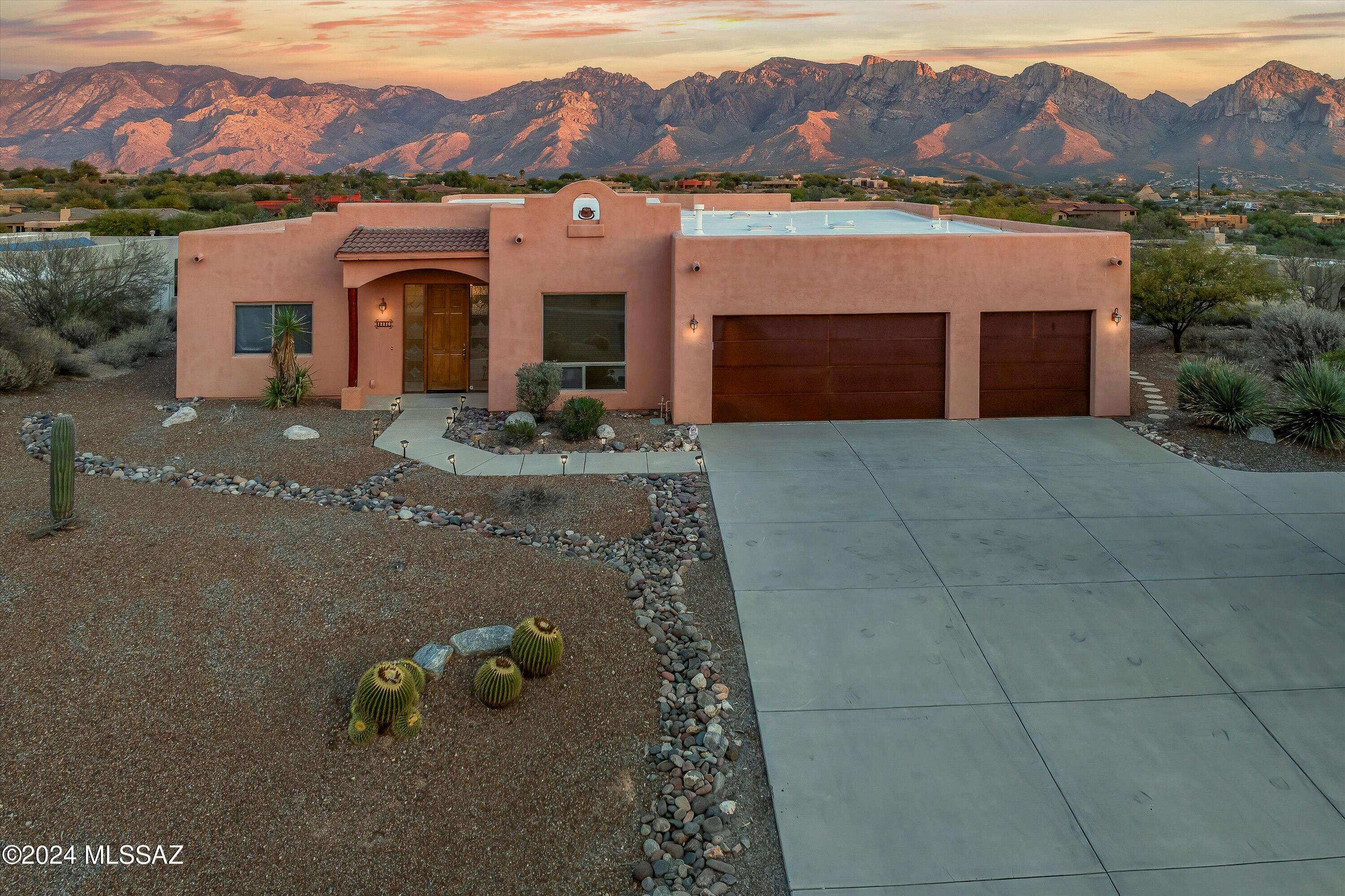 12210 N Copper Spring Trail In a valley where mountain views define luxury living, this estate claims the crown jewel position. Masterfully placed at the optimal elevation, this Santa Fe residence commands what are simply the finest, most complete views of Pusch Ridge available in Oro Valley. While neighboring properties catch mere glimpses, this home's privileged position delivers an unrivaled, front-row panorama of the Catalinas' most dramatic peaks. Every window frames what others can only envy - pure, unobstructed sightlines to the mountain's majestic spine, with no rooftops or power lines to mar the view. From your covered patio, witness nature's daily masterpiece as dawn ignites the ridgelines in brilliant gold and dusk paints the peaks in famous Southwest purples. Set on over an acre of pristine desert, this exceptional vantage point transforms each day into your private showing of Oro Valley's most coveted view - one that simply cannot be matched anywhere else in the region.
True to its Santa Fe heritage, this custom home masterfully employs traditional architectural elements to create a light-filled sanctuary. Authentic viga beams grace the ceilings, their rich wooden tones contrasting beautifully with the home's bright, airy spaces filled with natural light. In the chef's kitchen, custom knotty alder cabinetry, gleaming granite countertops, and stainless steel appliances blend seamlessly with these Southwestern design elements to create a space that's both beautiful and functional.
The great room epitomizes Santa Fe elegance with its soaring ceilings anchored by exposed viga beams, an architectural hallmark that continues throughout the home. Traditional nichos are artfully integrated into the walls, offering authentic Southwestern charm. Sophisticated tile flooring extends throughout, while a dramatic wall of windows frames the magnificent Pusch Ridge views. Glass doors lead to an expansive covered patio where classic vigas and corbels define the outdoor living space.
The outdoor entertainment areas are masterfully designed to maximize the mountain experience. A thoughtfully crafted flagstone patio features a gourmet built-in BBQ station and a classic kiva-style fireplace, creating separate zones for cooking and gathering. The integrated seating provides a comfortable perch to gather around the fire or simply soak in the majestic Pusch Ridge views. Whether you're grilling under the vast Arizona sky or enjoying the warmth of a crackling fire on a cool desert evening, this space captures the essence of resort-style living.
A split bedroom floor plan ensures privacy, with a luxurious primary suite that includes a spa-inspired bathroom featuring dual vanities, an oversized soaking tub, and elegant glass block windows that provide both natural light and privacy. The matching knotty alder cabinetry continues throughout the bathrooms, maintaining the home's cohesive design aesthetic.
The property showcases desert landscaping with mature saguaros, barrel cacti, and native plants, all connected by meandering rock-lined pathways. A private walking trail at the rear of the property provides your own personal hiking adventure, while the oversized three-car garage offers abundant space for vehicles and storage.
Positioned to capture both dramatic sunrises and the evening alpenglow on Pusch Ridge, this east-facing property offers front-row views to the Catalinas' most striking peaks. The outdoor living spaces frame these premium mountain vistas, where morning light bathes the peaks in gold and evening skies transform them into ribbons of rose and purple. This remarkable Oro Valley property artfully combines authentic Santa Fe architecture with a privileged vantage point of the Catalina Mountains. Properties with views of this caliber are increasingly rare in Oro Valley - contact Oliver Realty today to schedule your private tour.