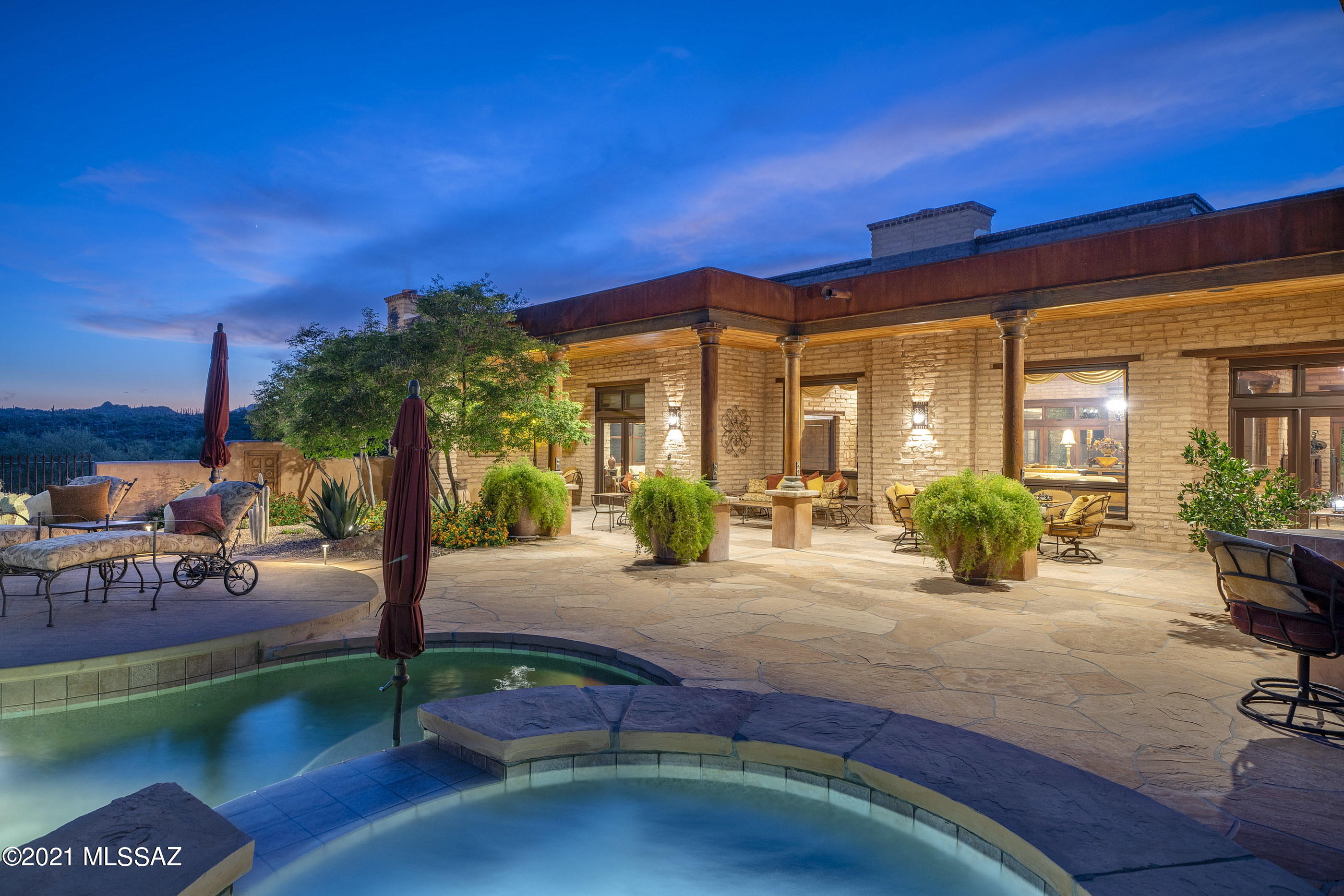 Located in the highly sought after community of The Estates at Honeybee Ridge. Set high on a premium view lot, this home is nestled within the lush natural desert landscape,  adding to the secluded feel of this estate property. An elongated veranda connects the shared living spaces, with a series of glass doors coordinated to tie the interior rooms to the spacious outdoor living environments, resulting in a perfect  juxtaposition of private and social spaces.Layers of covered patios are perfectly situated to enjoy year round, with views stretching out over Pusch Ridge and the Catalina Mountains beyond. Native vegetation provides a seamless background to the manicured grounds causing an explosion of color, light and shadow. Upon entry, you are greeted by a large "Great Room" with soaring ceiling heights acting as the central hall, inclusive of the formal living room to one side and dining, kitchen on the other, establishing the main connection point of the home. The private East wing of the residence features the sumptuously appointed owner's suite, with custom dressing closet and a luxuriously finished bath, including a large walk-in shower and soaking tub.

The floor plan comprises both formal and informal living spaces, equally suited for grand entertaining, as well as quiet moments, with a chef's kitchen where every measurement and detail has been carefully considered, boasting an oversized custom center island, designed to appear as furniture, complete with top-end fit and finish, including a La Cornue Grand Palais 180 range. Almost 6 feet in length, this handcrafted detail of absolute perfection is the crown jewel of the La Cornue | Château Series, commanding respect and admiration in any kitchen.

This very private lot offers a series of patios and exterior living spaces designed for outdoor entertainment. The SW covered patio offers an outdoor kitchen, complete with a barbecue station, gas cooktop and sink with endless counter space and bar top. The veranda incorporates a masonry fireplace and covered dining patio, perfectly designed to the home's effortless blend of laissez-faire.

A succession of courtyards results in varied focal points, unwinding like a garden narrative of texture, light and mood. Every comfort considered and detail meticulously crafted, results in a home that offers a sense of easiness to enjoy both lifestyle and entertainment. 


About the Area:

Honeybee is rich in Arizona History. The canyon that borders the west side of the development is called Honeybee Canyon. According to archeologists that have studied the area, the Native American Hohokam Indians discovered this area and were using Honeybee Canyon from the earliest of times.

Honeybee Ridge is a unique development consisting of 128 Custom Home Sites. The development is smaller than most of its competitors. No resorts, no high-density development, no golf courses, just a nice, quiet, peaceful place to enjoy Arizona living.

The Estates at Honeybee Ridge encourages its residents to be creative with high-quality materials and designs that are conducive to our wonderful landscape. When the development is complete, 128 custom homes will be built, all homes will be single-story, lot sizes are a minimum of one acre and design guidelines limiting disturbance to 16,000 feet per lot (not including driveway) will keep 75% of the development pristine & untouched.