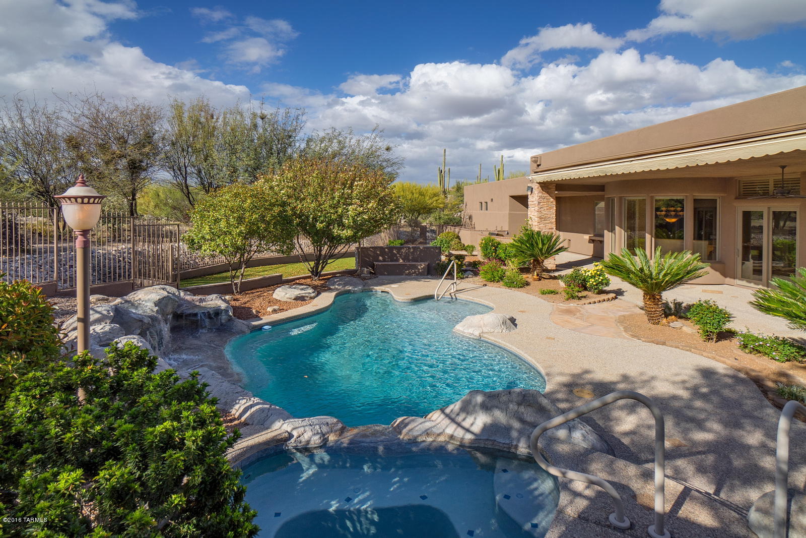 A TAR HOME TOUR WINNER*BELOW APPRAISAL* Stunning Custom Home in Gated Honeybee Ridge Estates.Nestled on a Private Parcel of Saguaros & Rock Outcroppings. Large Kitchen w/Nook & Breakfast Bar; Prep-Sink; Kitchen Island with seating; Lg.Great Room; Stone FP, Wet Bar, Formal Dining and Mountain Views. Grand Foyer Entrance;Huge Master Suite & Bath; Professionally Landscaped with Waterfall Feature at Entrance. Rose Courtyard Front Patio;Very Private Pool & Spa Backyard; Built-in Grill with Over-sized Covered Porches for Outdoor Entertaining.Architectural Stone Appointments inside & out;High Ceilings;Custom Paint; Natural Stone Floors;Granite Counter Tops;New Tile Roof.Hunter Douglas Blinds;Plantation Shutters; Ceiling Fans & MORE.4-Car garage has Air Conditioned BONUS Room with private entrance