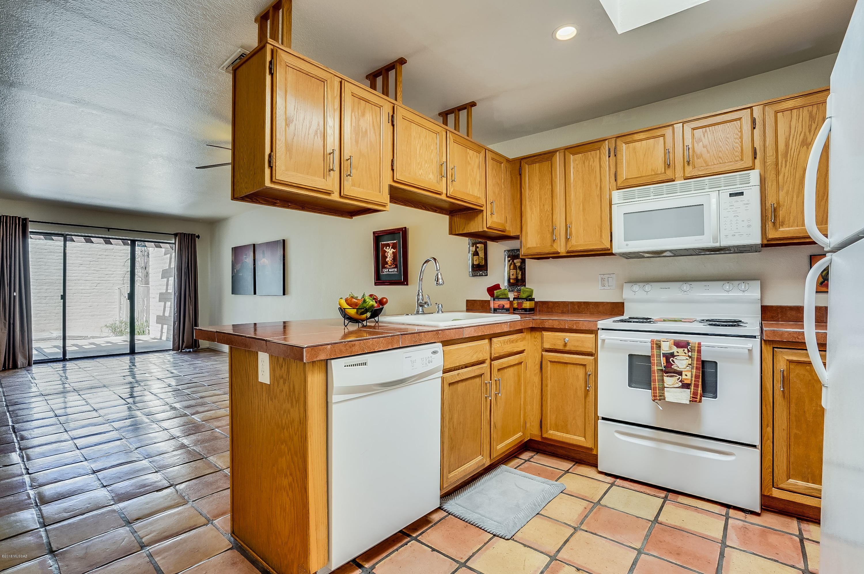 Seller will accept or counter offers between $150,000-$155,000. Absolutely delightful town home with Catalina Mountain views from master bedroom balcony! Enjoy the open living area with satillo tile throughout the lower level.  Great floor plan with one bedroom/one bath downstairs and the master bedroom/bath located on the second floor.  Spacious rooms, great views, small community with beautiful pool/spa in a park like setting. What more could you ask for? One garage space, private carport and generous patio area.  Security camera system, living room tv, and all appliances convey!   Owner replaced carport, carpeting, garage door, kitchen lighting, added storage, replace balcony flooring and master sliding door.  You won't be disappointed!  Owner may carry with large down/acceptable terms.