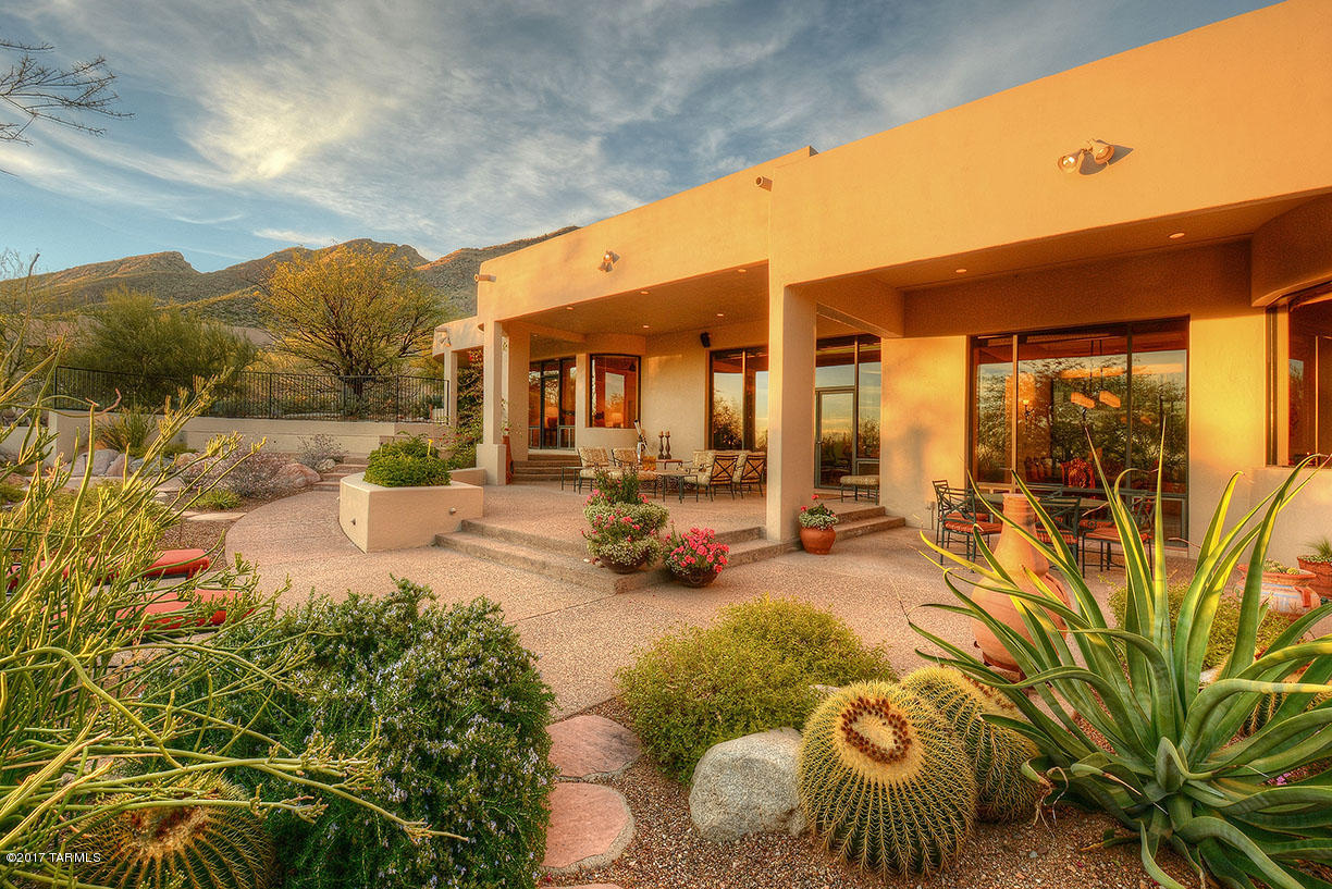 Stylishly Updated 4 BR/4 BA Contemporary Home Perched High Above Tucson in Guard Gated Finisterra.Commanding City & Mountain Views Throughout. This Masonry Built Home Features a Private Courtyard Entry w/Waterfall,Light & Bright Living & Dining Rooms w/High Ceilings,Copper Faced Gas FP, Bose System & Remote Shade Screens. An Island Kitchen Offers Honed Granite Countertops & SS Appliances Opening to a Breakfast & Sitting Area w/Fireplace. Spacious Master Suite w/Spa-Like Bathroom + His & Her Walk In Closets,Executive Office w/Built-In Desk & Shelving,One En Suite Guest Room & 2 Guest Rooms w/Jack and Jill Bath.Other Fine Features Include,Flagstone Floors,3 Car Garage w/ Storage Rooms,Oversized South Facing Backyard w/Sitting & Dining Areas,Built In BBQ & Sparkling Hot Tub w/Waterfall