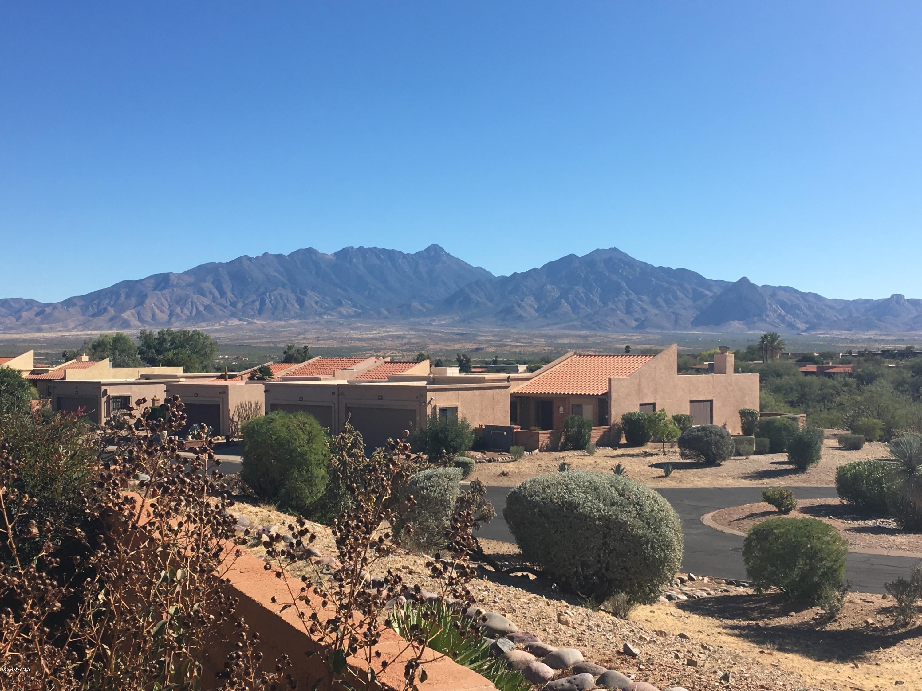 Enter this lovely townhome through your gated entry way. High ceilings, LOTS of space, & storage. Enjoy your morning coffee out in the back while looking at the Sunrise over the Santa Rita Mountains. 2BR/2BA Home with LOTS of light, storage & and AZ Room. 2 Car garage boasts storage cabinets and work area. Come take a look. Carpets have just been professionally cleaned.