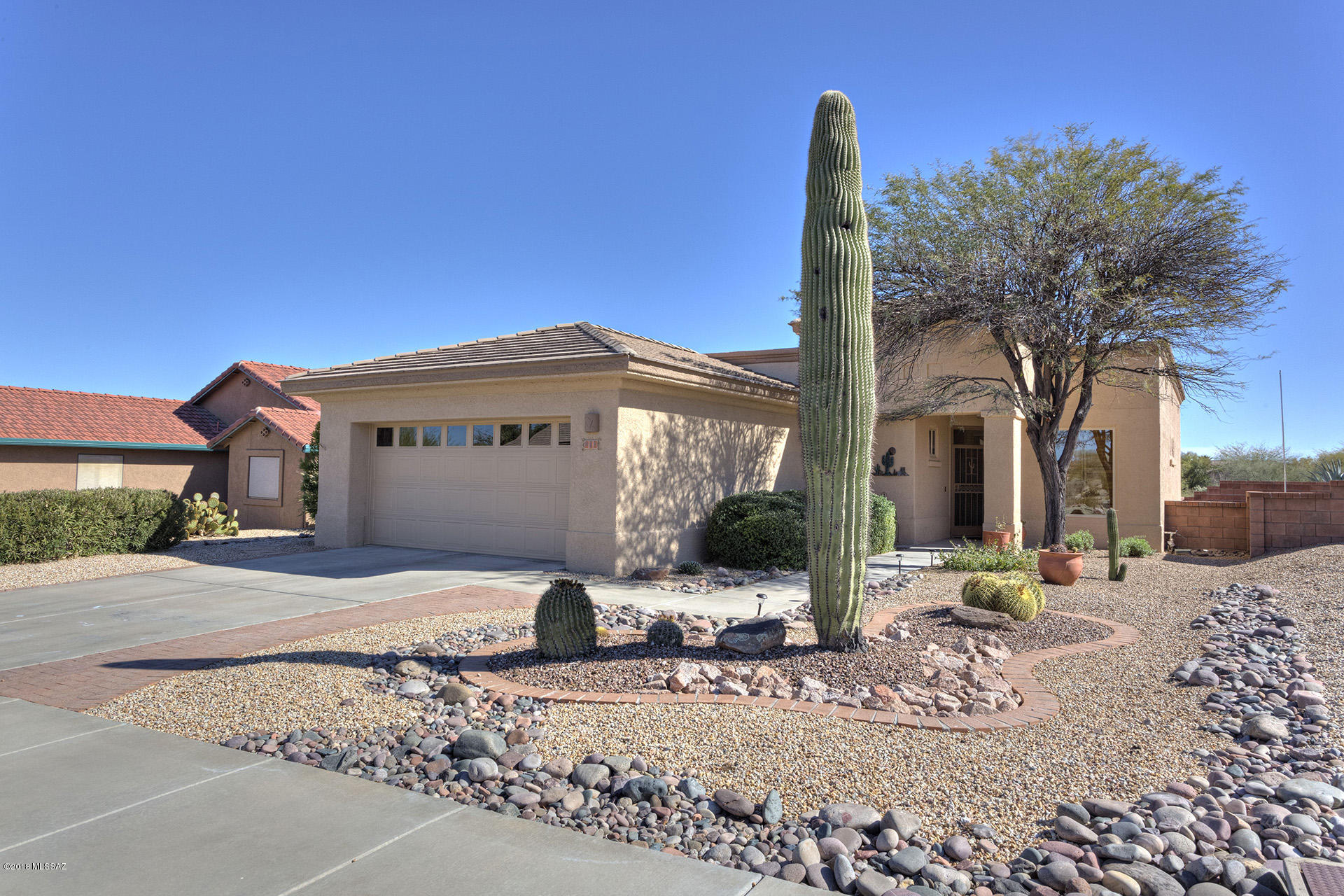 Spectacular home with terrific Mountain Views. Just a perfect home! 2 bedrm-split, 2 bath, den, laundry rm generous size w/utility tub, open great rm-walls of windows, gas range at kitchen-window above kit sink, higher ceilings,great storage, lovely designer upgrades through. Easy care landscaping with excellent views from the inside and the back patio. All tile floors. Newer HVAC--whole home nicely maintained