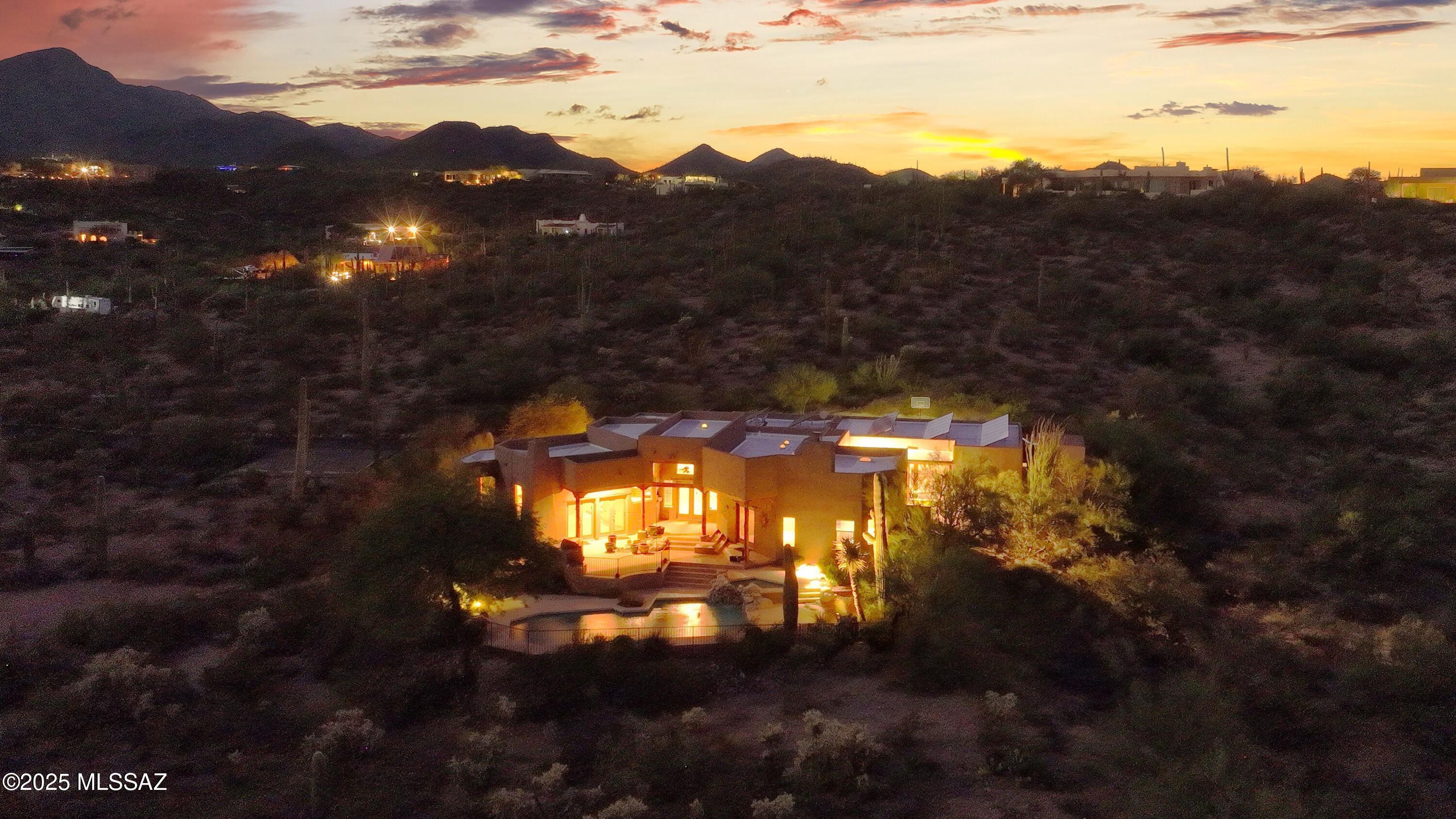Stunning, private southwestern-style custom home, nestled on 3.3 acres of lush Sonoran desert landscape. Spectacular mountain & city views from this special setting. Nearly 100 Saguaros on the property & only 1,000 feet from the Saguaro Natl & Tucson Mountain Parks with over 200 miles of hiking & horseback riding trails. Located within 10-15  minutes of all amenities imaginable. This efficiently designed home boasts 5 BR & 3 BA, a spacious multipurpose bonus room, a large 3 car garage & a beautifully remodeled kitchen with granite counters & new appliances. The luxurious master suite showcases a fireplace, vega beam ceiling, a deep soaking tub, custom slate shower, double vanity & a walk-through closet. Owned solar for lower utility costs! Brand new exterior wood beams and ext paint! STUNNING SOUTHWEST STYLE HOME 
Discover the perfect blend of rural tranquility and city convenience in this stunning southwestern-style home, nestled on 3.3 acres of lush Arizona-Sonora Desert landscape. Just a quick 5-minute drive from the freeway and 10 minutes from vibrant city amenities - restaurants, shopping, and more - this property offers the best of both worlds.
NATURE AT YOUR DOORSTEP
Located a mere 1,000 feet from Sahuaro National Park and Tucson Mountain Park, you'll enjoy access to 200 miles of hiking and horseback riding trails. The property is dotted with nearly 100 Saguaros, providing a serene and private oasis with breathtaking views of both city lights and majestic mountains, perfect for watching spectacular sunrises and sunsets.
THOUGHTFULLY DESIGNED CUSTOM HOME
This custom home maximizes space with an efficient floorplan featuring extra high ceilings adorned with vega beams and wood planks. The recently remodeled kitchen boasts new appliances, beautiful granite countertops, and a unique custom mesquite island. Skylights and Solatubes throughout the home bring in natural light, creating a warm and inviting atmosphere. Some skylights have just been replaced. Brand new exterior wood beams with natural stain. Brand new exterior paint and more!
VERSATILE SPACES
The extra-large 3-car garage includes built-in cabinets for ample storage. A multi-purpose room serves as a media room and can easily convert into a guest space with its hidden Murphy bed. The five bedrooms offer flexibility for family needs, with options for a den or office. One bedroom features a private entrance to a landscaped patio, enhancing privacy.
LUXURIOUS MASTER SUITE
The luxurious master suite showcases a fireplace, vega beam ceiling, and stunning views. The bathroom is a retreat, featuring a deep soaking tub, custom slate shower, double vanity, and a walk-through closet designed for maximum storage.
ENERGY EFFICIENT LIVING
Stay comfortable year-round with an efficient propane heating and A/C system, maintained under a service agreement through 2028. Ceiling fans in every room ensure optimal airflow, while rooftop solar panels keep energy costs low, with average electric bills around $20/month.
LOW MAINTENANCE LANDSCAPING
Enjoy a beautifully landscaped yard that harmonizes with the surrounding desert. Drip irrigation keeps it vibrant, allowing for seasonal flowers in patio pots without the hassle of high maintenance.
PERFECT FOR ANY LIFESTYLE
Whether you're a young family or looking to downsize, this one-owner home caters to every stage of life. Experience the tranquility, beauty, and convenience this exceptional property has to offer!
Don't miss your chance to make this stunning home your own!