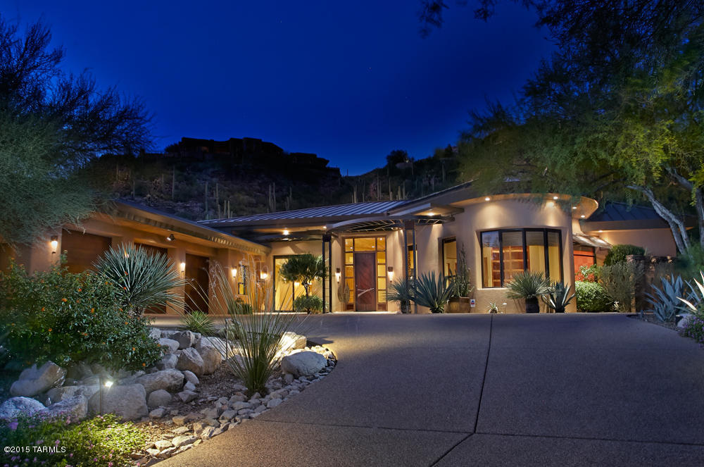 A stunning architectural masterpiece in Ventana Canyon C.C Est. nestled into a 1.2ac saguaro studded lot to provide views & privacy. Enter through the custom metal front door into the grand liv.rm w/floor to ceiling walls of windows, wood planked ceilings, custom built-ins, travertine floors throughout & an elegant dining rm w/bar. The epicurean kitchen features granite counters & backsplash, high end appliances & a butlers pantry. Mstr bdrm wing features a luxurious bathrm w/steam shower, 2 closets, Jacuzzi tub & private office w/custom built-ins.  3 spacious guest rooms, Stunning bathrms & designer finishes are found throughout this home, all on one level w/NO steps- a rarity in Ventana! Lush desert gardens, pebbletec pool/spa & built-in grill make for an entertainer’s outdoor paradise