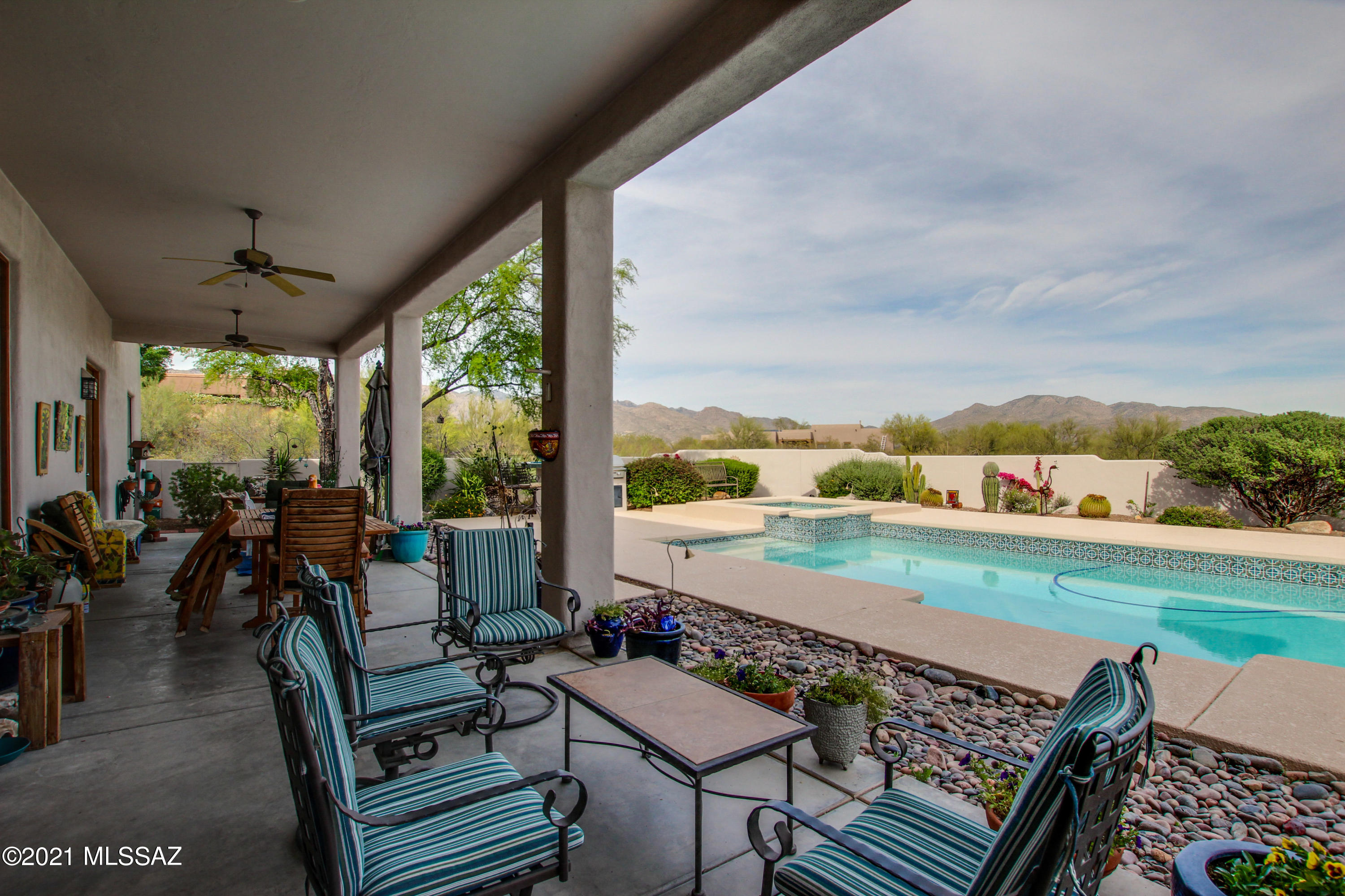 Immaculate Southwestern style home located  in the Green Ridge subdivision. 1.67 acre lot with panoramic views of the Rincon and Catalina Mountains. Three car garage with work area. Spacious four bedroom split bedroom floor plan with skylights throughout giving the home tons of natural light. 30 x 15 volleyball pool + Spa with a wide open view of the Rincon and Catalina mountains. Home improvements include the roof being recoated in 2021, cool deck replastered 2021, new barbeque 2021, new pool pump and heater and lots more! Take a look at the home improvements & features under documents).  Backyard is your dream oasis with a large sparkling pool and spa , a spacious covered patio equipped with ceiling fans, new barbeque (2021) and so much more! Schedule a showing today!