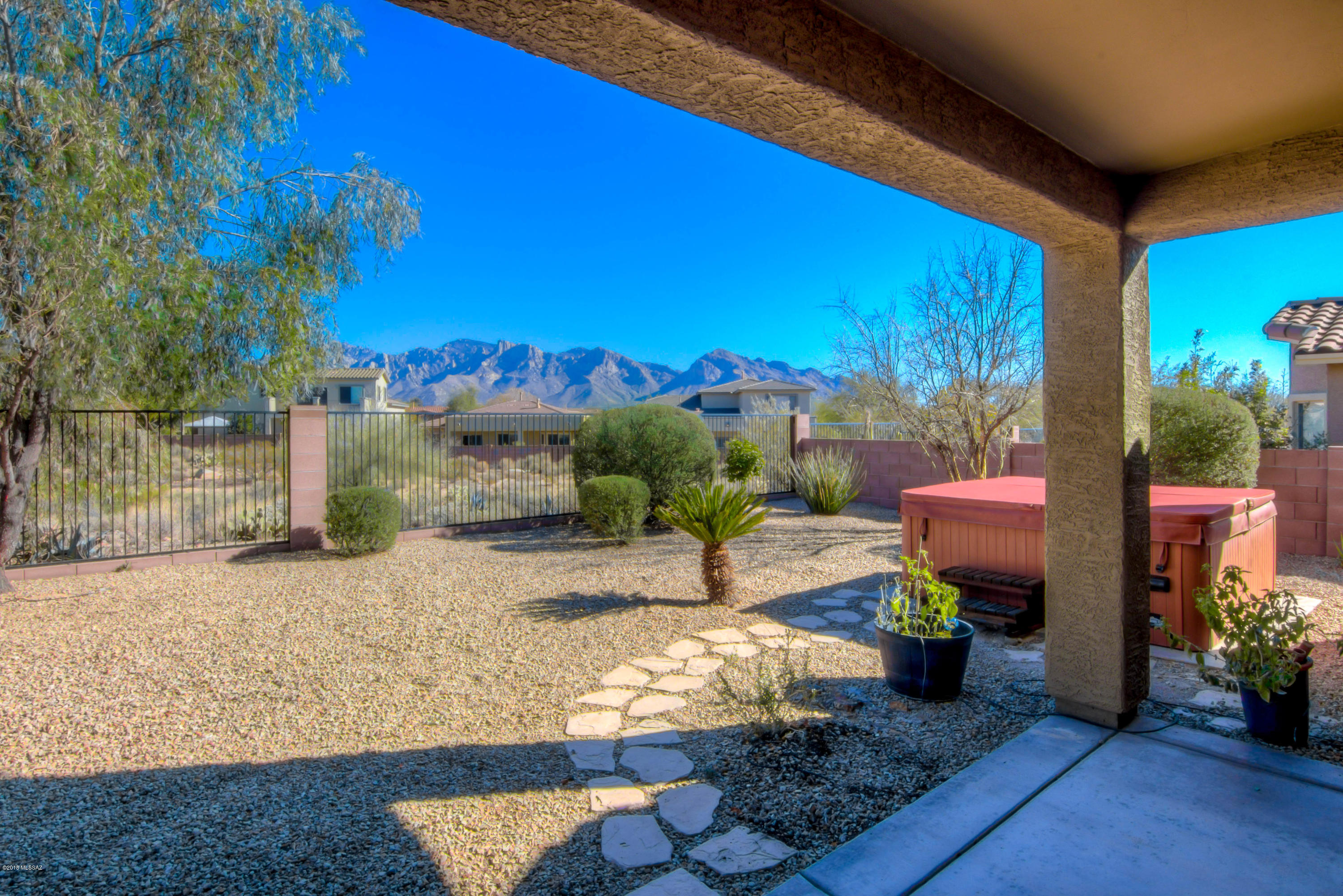 Looking for a well-maintained home with Views?...Look no further! Awesome Catalina Mountain views. Many extras include Upgraded Soft Close Drawers in kitchen cabinets, kitchen island, and beautiful Corian Counters. Owner's suite has Bay Windows w/stunning Catalina Mountain Views. Custom flooring has 20'' tile set on the diagonal except the family room and 3 bedrooms. Den w/closet can easily be converted to 4th bedroom.  Covered patio, hot tub, low-care landscape and spacious natural desert buffer away from direct backyard neighbors. Close to shopping and excellent schools. Exceptional Oro Valley home!