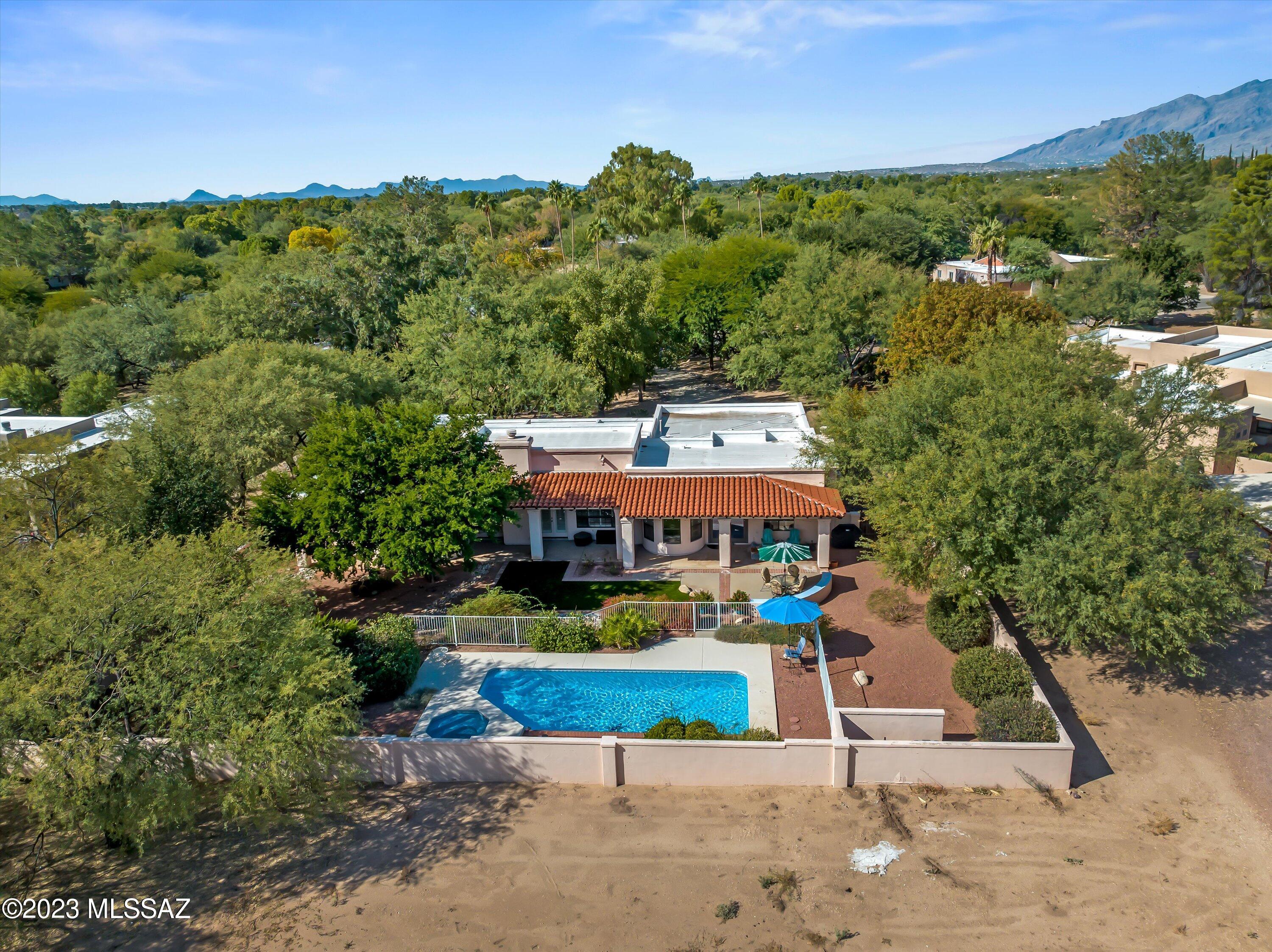 Seller will entertain offers from $798,000 - $825,000. Treasured home that boasts panoramic Catalina and Rincon Mountain views. Tucked away on an lush acre  of mature trees and landscape in 49ers Country Club. Courtyard entry welcomes you to the 4 BR/ 3 BA encompassing 2905 sq. ft. Open design offers soaring ceilings, polished concrete flooring, plantation shutters, clerestory and expansive windows that bring the outside living in. Gourmet kitchen with double oven and gas cooktop with granite counters, alder cabinetry that opens to dining nook with bay window. Family and living rooms boast a fireplace & surround sound. The backyard is an entertainers' delight complete with covered patio, tantalizing heated pool and spa, turf and majestic mt. views.