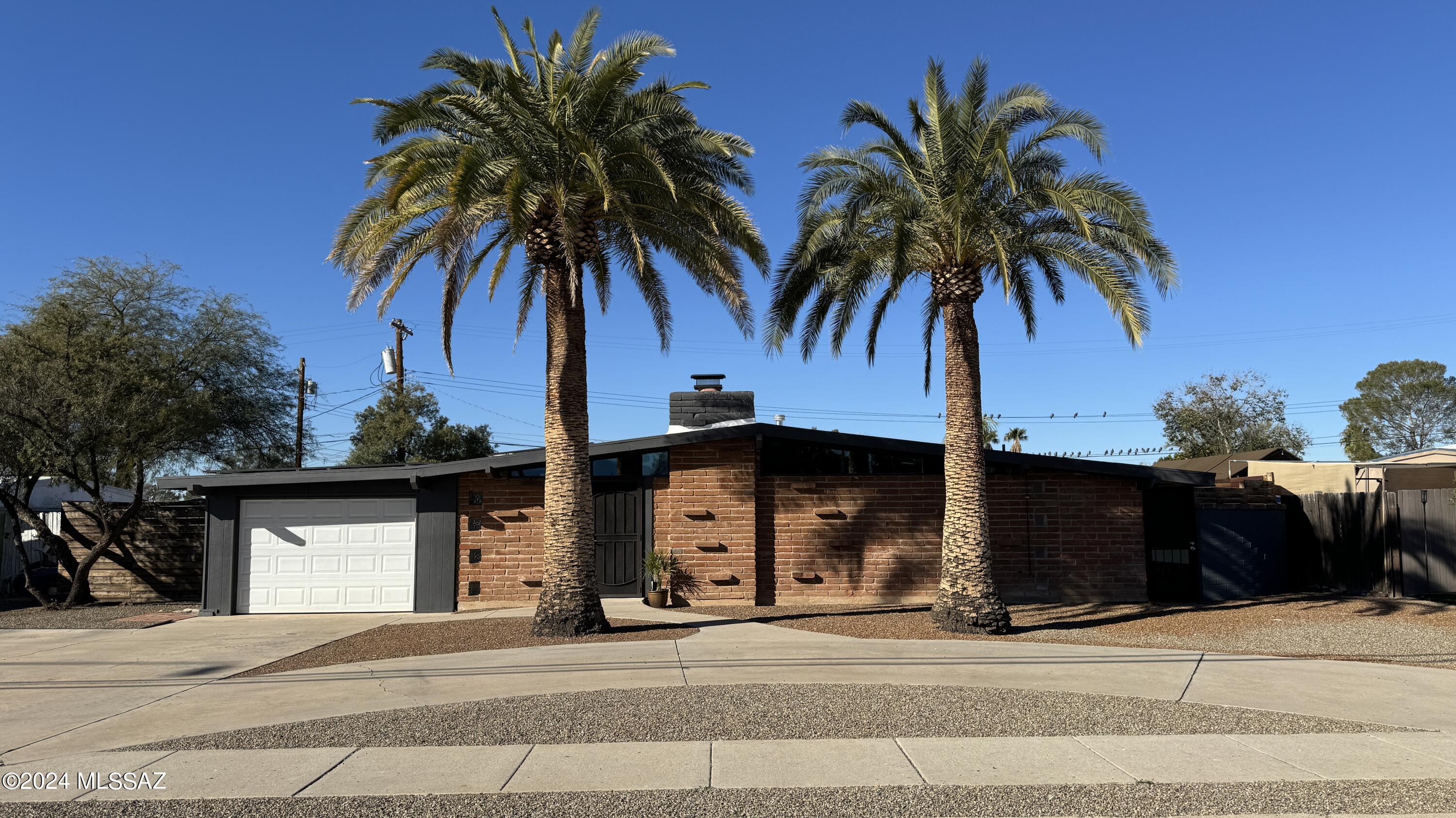 Mid-century charmer with private backyard oasis with pool and spa. This former model home has been updated throughout the years with new clear-story windows, fireplace, iron gates, solar & roof to name a few. With 3 bedrooms, 2 baths, this light and bright home makes a wonderful retreat right in the heart of Tucson within walking distance to restaurants, shopping, entertainment, and bus routes. (Above ground spa stays- Additional Endless pool/spa to convey on separate bill of sale)