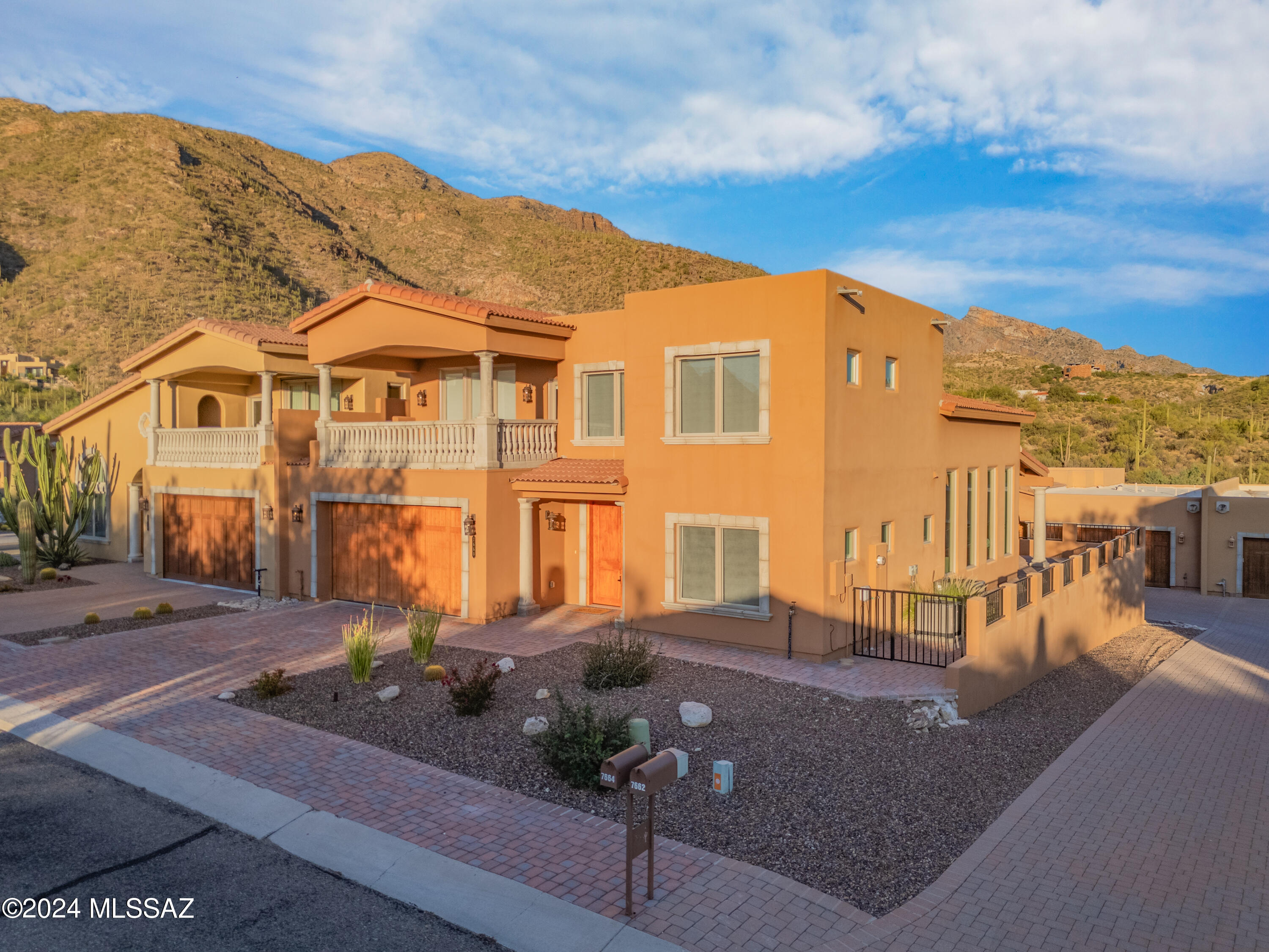 Experience luxury living at its finest in the desirable Sin Vacas community with this exquisite 5-bedroom, 3.5-bathroom home, offering 2,740 sq. ft. of elegant space. Enjoy stunning views of the Catalina Mountains and the city skyline from every angle. The lower level features a gourmet kitchen equipped with white quartz countertops, modern white cabinetry with black accents, a stylish tile backsplash, a convenient walk-in pantry and high-end stainless steel appliances. The open layout seamlessly connects the kitchen to the dining area and living room, perfect for entertaining. You'll also find a guest bedroom, a laundry room, and a spacious primary suite that features French doors leading to the patio, dual vanities, a beautifully tiled shower and a generous walk-in closet.