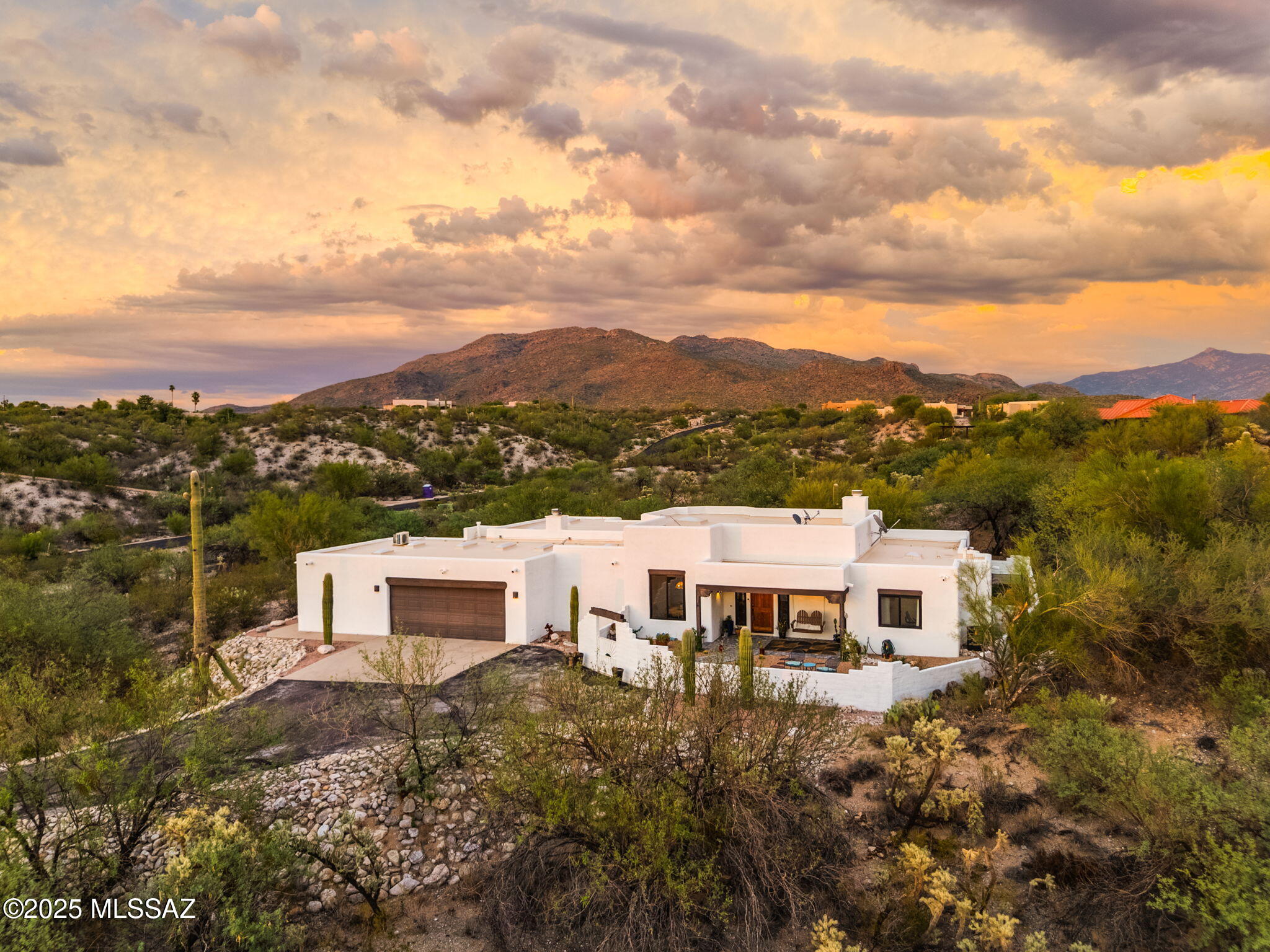 Rare Opportunity in Saguaro Trails-Gated Luxury Living on 3.33 Acres! Nestled within the top-rated Vail School District. Situated on an elevated 3.33-acre lot, this beautifully renovated home offers breathtaking panoramic views of the mountains, sunrises, and sunsets. Step inside to discover engineered hardwood floors throughout (no carpet!), tastefully remodeled hall and powder baths, and a spacious primary suite featuring a cozy gas fireplace, private patio access, and a large walk-in closet. The open-concept great room with soaring vaulted ceilings and a second gas fireplace flows effortlessly into the kitchen, complete with stainless steel gas appliances, a breakfast nook, and a formal dining area. Enjoy added flexibility with a large bonus room-perfect for guests, office, or studio- complete with a Murphy bed, private entrance, and its own heating/cooling system. Upgrades include new Andersen windows, new pavers in the front courtyard and backyard, new turf and irrigation, two new HVAC systems (installed 2/2025), new water heater, and a freshly recoated roof (2023). The sparkling pool with removable safety fencing completes this move-in-ready gem. Enjoy privacy, views, and upscale desert living in this exceptional home! Playset, front porch swing & 1 planter does not convey. VA Assumable loan at 2.75%