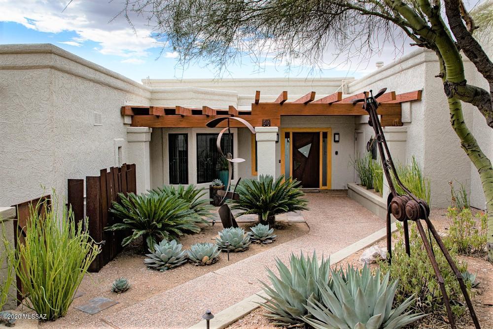 Adjoining 29,185 Sq. Ft. lot preserves the valley views shall be sold with, and included in, the home purchase, for a total of approximately 1.29 acres. The incredible 4435 Sq. Ft. cul-de-sac home has breathtaking views day or night. Calming great room & impressive dining area. Dramatic spaces for art & sculpture. Seller's wing: sitting area, see-thru FP, private patio; luxurious his/her bath, labradorite counters, 2 refrigerator drawers, heated shower floor, laundry, floor-space for massage table. Custom kitchen is a gem W every appliance, wide door to huge covered deck; gas grill; views; all off comfortable Family Rm, Bkfst area, Pwdr Rm. Lg storage Rm w add'l W/D, Refrig, Freezer hook-ups. Exceptional remodel, built-ins and addition  Perfect home for permanent or seasonal Tucson living connected to outdoors! Sold turnkey.