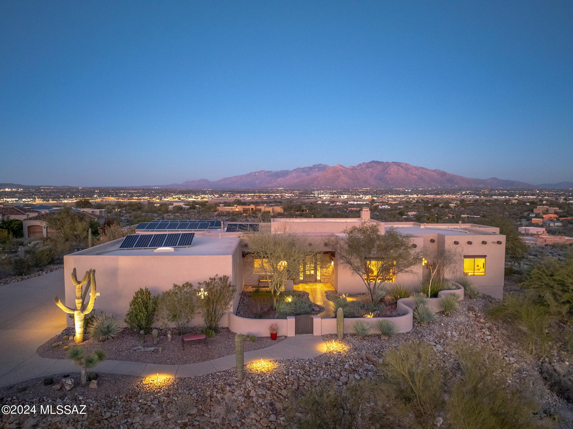 Views! Views! And More Views of Tucson Valley and mountains are a couple features of this amazing home! Nestled on 3.3 acres in the gated community of Tucson Mountain Reserve, this property offers resort style living with privacy and comfort. As you step through the custom wrought iron & glass door, you'll see over four thousand square foot of living area that has views in almost every area of the home. This Santa Fe inspired home has high ceilings with exposed wooden Viga beams comes with 6 bedrooms, 3 full bathrooms, an oversized 3 car garage, formal dining area, breakfast area, and an open floor plan that connects the kitchen with the living area. The Chief's kitchen has a large center island with quartz countertops, lots of cabinet space for storage, wine fridge, and comes with all stainless steel appliances including a subzero refrigerator & Wolf gas range, hood, and double oven. There's no carpets throughout the home. All the 6 bedrooms have porcelain tile installed and one of the bedroom has a wall bed that conveys. The primary bedroom is very spacious with 2 walk-in closets, its own fireplace, exposed beams, access to backyard, large shower, and a corner soaking tub with views! With many rooms, one can make a room an office, home gym, wine cellar, or guest rooms.
  	One of the best features of this home is the backyard. Push the folding patio doors together to have a space that the outdoor and indoor flow seamlessly. This backyard is an entertainer's paradise! It includes multiple outdoor kitchens with gas & wood / charcoal grills, an outdoor wood pizza oven imported from Portugal, built in ice chests, 4 copper natural gas firepits, large seating areas, and a negative edge pebble tech pool with spa that will be perfect for get togethers with family & friends at any time of the year. But most importantly, anyone there will see that the backyard area offers the most beautiful panoramic mountain views or at night, a lit up city full of lights! Current owner spared no expense on property with landscape upgrades includes purchasing 19 saguaro cactus to add to the land with now over 49 saguaros all together, purchase solar system since 2016 that hasn't had an electric bill since, had the outside exposed Viga beams capped in copper plating, new epoxy floors in garage, and just got the whole outside painted just to name a few. The pride of ownership shows! A once in lifetime opportunity to be the homeowner who gets to see these majestic views of sunrises and sunsets on either sides of the house, live in an amazing community, and have easy access to I-10. Come see today!! AND ask about a twilight showing.