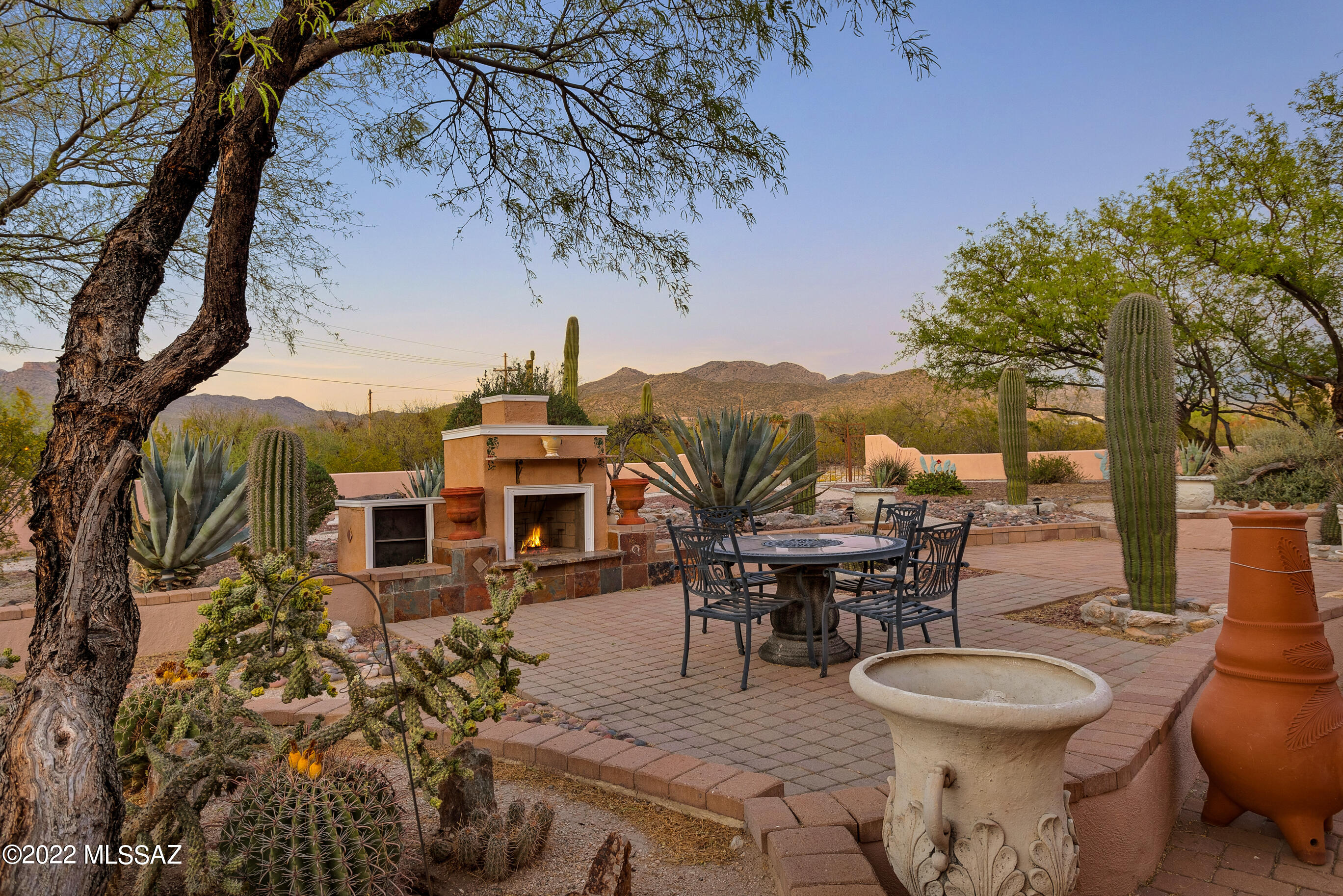 A Mediterranean home in the desert! Nestled in the desert! Nestled in the Tanque Verde Valley, featuring mountain views of the Rincon & Catalina mountains, this home was custom designed for this lot. With a private gate, this home is set back so as to remain hidden from the street. But with 3+ acres & no HOA, you still have room to add horse facilities, workshop, guest house, etc. Hand carved marble fireplace surround & hand painted interior columns at the 12 foot ceilings impress when you walk in the door. A media room is tucked away behind the kitchen with a wet bar and 2 fridges. Plus a bonus room off the formal living area can be converted to bedroom, office, music room, etc. The grand master suite has its own fireplace, 2 walk in closets and bonus interior room. This home abounds with space and possibility!