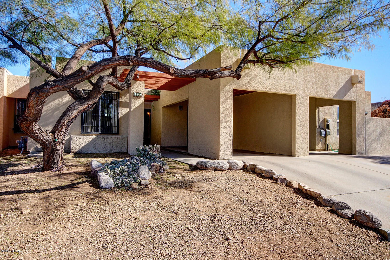 Beautiful Central Tucson town home with no homeowner's association dues is awaiting your arrival! This charming home offers an open floor plan with designer paint and tile flooring in all the right places. Galley style kitchen boasts white appliances, custom cabinets and corian counter tops. Three spacious bedrooms have plush carpeting. Master bedroom also includes an adjoining bath. Generous backyard is complete with an enclosed covered patio and desert landscape. All appliances stay. This gem is ready to be discovered! See it today! See it, love it, & live in it!