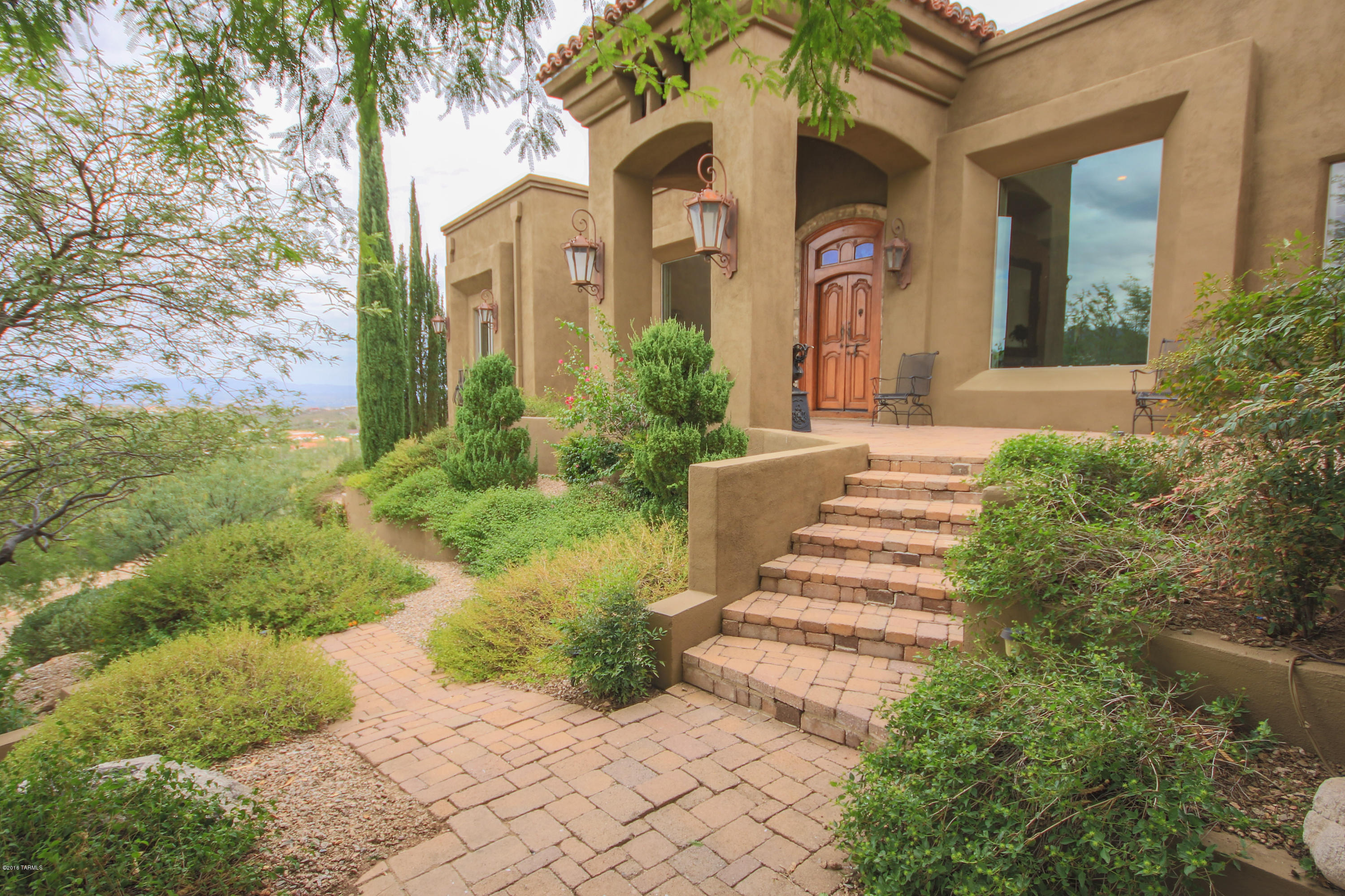 Immaculate Tuscan style estate with spectacular panoramic mountain & city views from every large window, front porch, & all patios! Bask in the absolute elegance of the sky high vaulted ceilings, awe-inspiring chandeliers, separate formal dining & living rooms, Travertine flooring, lovely library, & expansive great room perfect for entertaining! Gorgeous gourmet kitchen features a 6 burner Viking stove, huge center island, stainless steel appliances, granite, & custom cabinetry! Massive master suite hosts his & her closets, separate shower, custom tub with views, & grants access to your own private oasis in the backyard! The exterior features beautiful landscaping, intricate rock designs, 1 of 3 soothing fireplaces, a covered patio, sparkling pool, hot tub, & endless extravagant views!