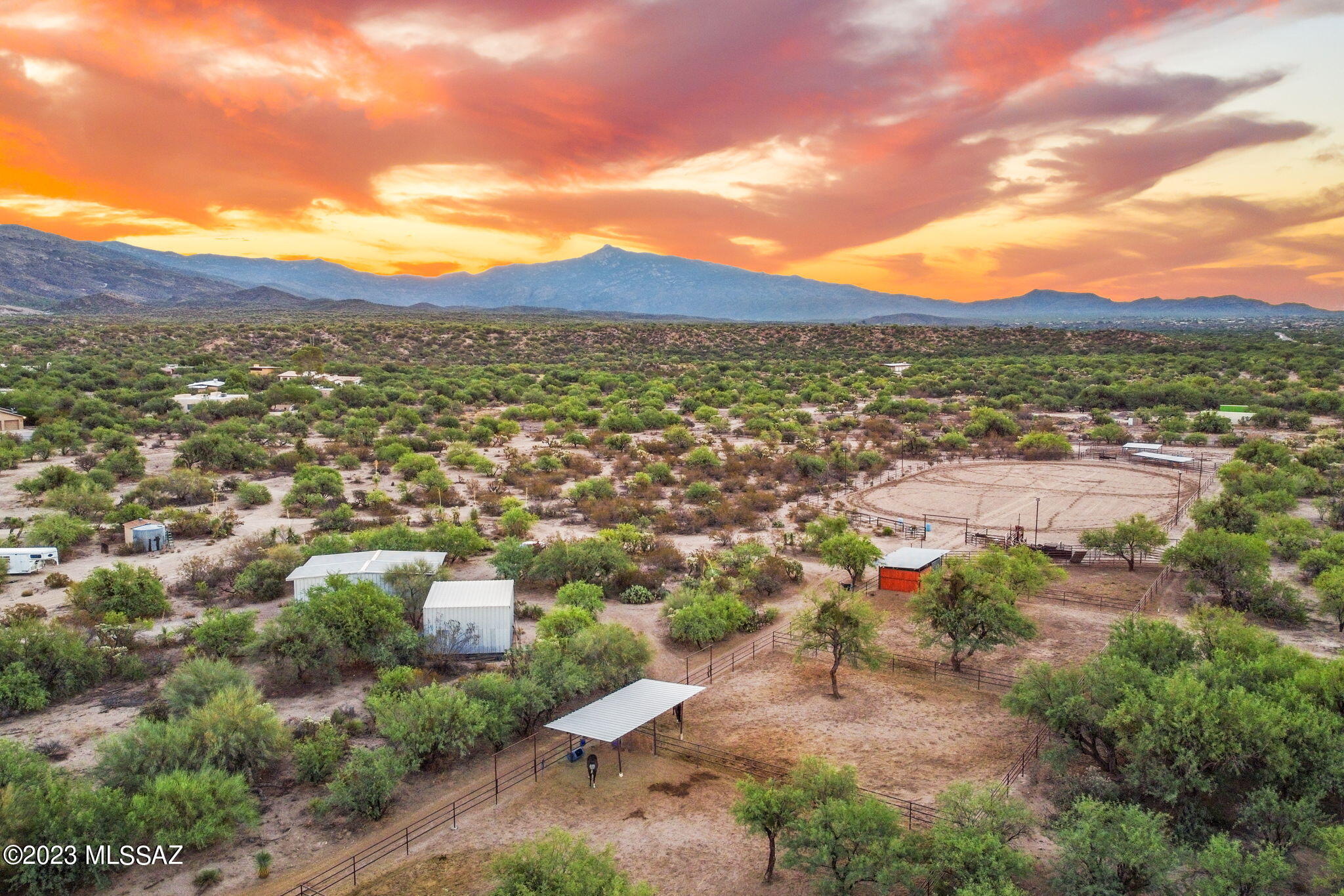 Rare 24.86-acre Southern Arizona ranch only minutes from town; with full-size arena (~440'x270'), 6 pens w/shades, tack room, workshop, and hay barn. This home is a masterpiece, showcasing the finest craftsmanship with Rastra Block construction, metal roof, and exquisite handcrafted cedar beams and ceilings. Step inside this timeless 2840 sq.ft residence, where the essence of the Southwest comes alive with handcrafted alder wood floors, windows, doors, and cabinetry. Indulge and relax in the spa or unwind under the front & back patios, soaking in the tranquility of the desert. With 3 bed/2.5 bath, a den featuring a cozy beehive fireplace, a 3-car garage and covered RV parking, this property offers space for all your needs. Don't let this amazing opportunity slip away