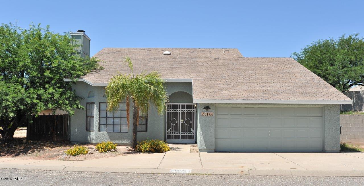 Updated 4BR 3BA.Just painted in & out.Stunning granite counters in kitchen.Lots of counterspace.Refinished kitchen cabinets have a rich, beautiful look.Gorgeous 18'' tile downstairs.New oil-rubbed bronze fans downstairs. Living rm has stacked stone fireplace & a bay window. Master suite is downstairs and has a walk-in closet, and sliding glass door to rear of home.New matching pedestal sinks in master bath.Shower has tiles all the way to the ceiling. 1/2  bath downstairs makes it convenient for guests.3 bedrms upstairs,each w/oak laminate floors and ceiling fans. Middle upstairs bedrm has sliding glass doors to approx 12x25 covered deck.Garage has workbench & storage cabinets. Fenced yard wraps around all 3 sides of home.Approx 12X25 covered patio off family rm.Owner licensed AZ Realtor.