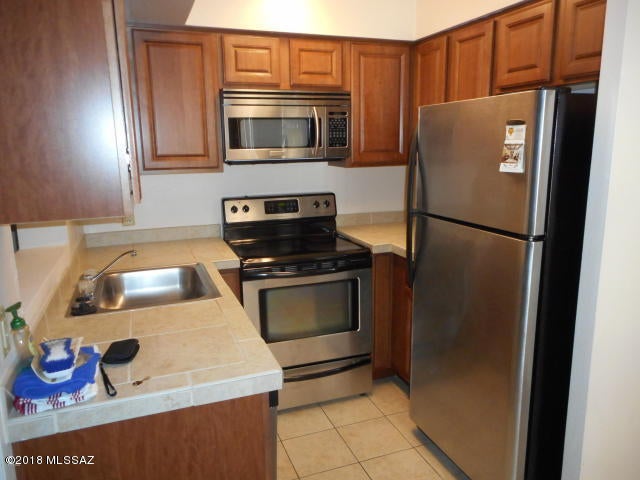 Brand-new Bedroom carpet, easy-care ceramic tile in living areas & all freshly painted! Lots of oak kitchen cab's, stainless appliances & microwave & DW! One rsv'd cov'd prkg space, on-site laundryrm, nice north-side patio w/extra storage & gorgeous view of the Catalina Mtns! Gated community w loads of amenities: new tennis ct, vb & rb, 2 pools & spas, indoor sauna & fitness cntr! Owner pays water! Easy 1.5 mi to UofA, on busline & near bike path! Great rental value for off-campus housing & close to Campbell Ave shops & dining & more!