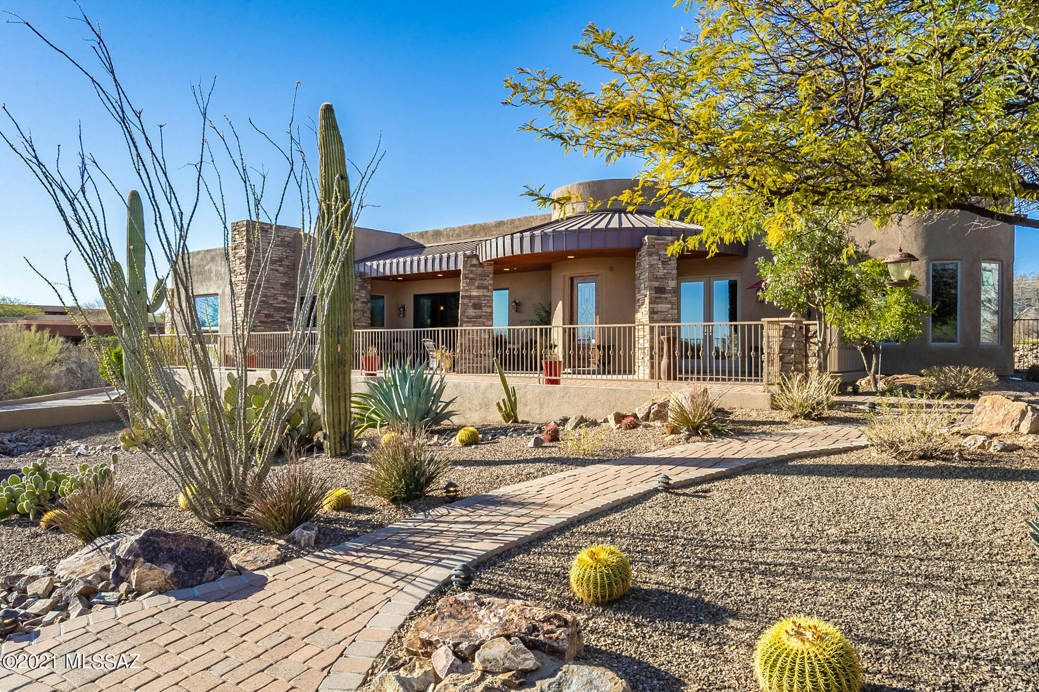 Beautifully tucked away custom Home in quiet Oro Valley neighborhood. Situated perfectly to capture amazing Pusch Ridge Views and City Lights. Split bedroom floor plan with 4 bedrooms, 3.5 bath , 3 car garage & paver driveway. Large master suite with sitting area & bath complete with whirlpool tub and walk-in shower. Gourmet, kitchen boasts custom made Alder cabinets, upgraded appliances and Viking induction cooktop. Private guest suite w/full bath and opens up to the backyard Spacious 4th bedroom/office w/separate entrance. Open & bright Great Room w/pass through fireplace into the dining room & 4 panel sliding door opening up to patio of spectacular mountain views. Private back yard with pavers & built in BBQ island, turf green and fire pit. This home was built with efficiency in mind. Passive solar design & spray foam insulation. Anderson windows with Sun Reflecting Low E windows. All appliance locations have gas option available.