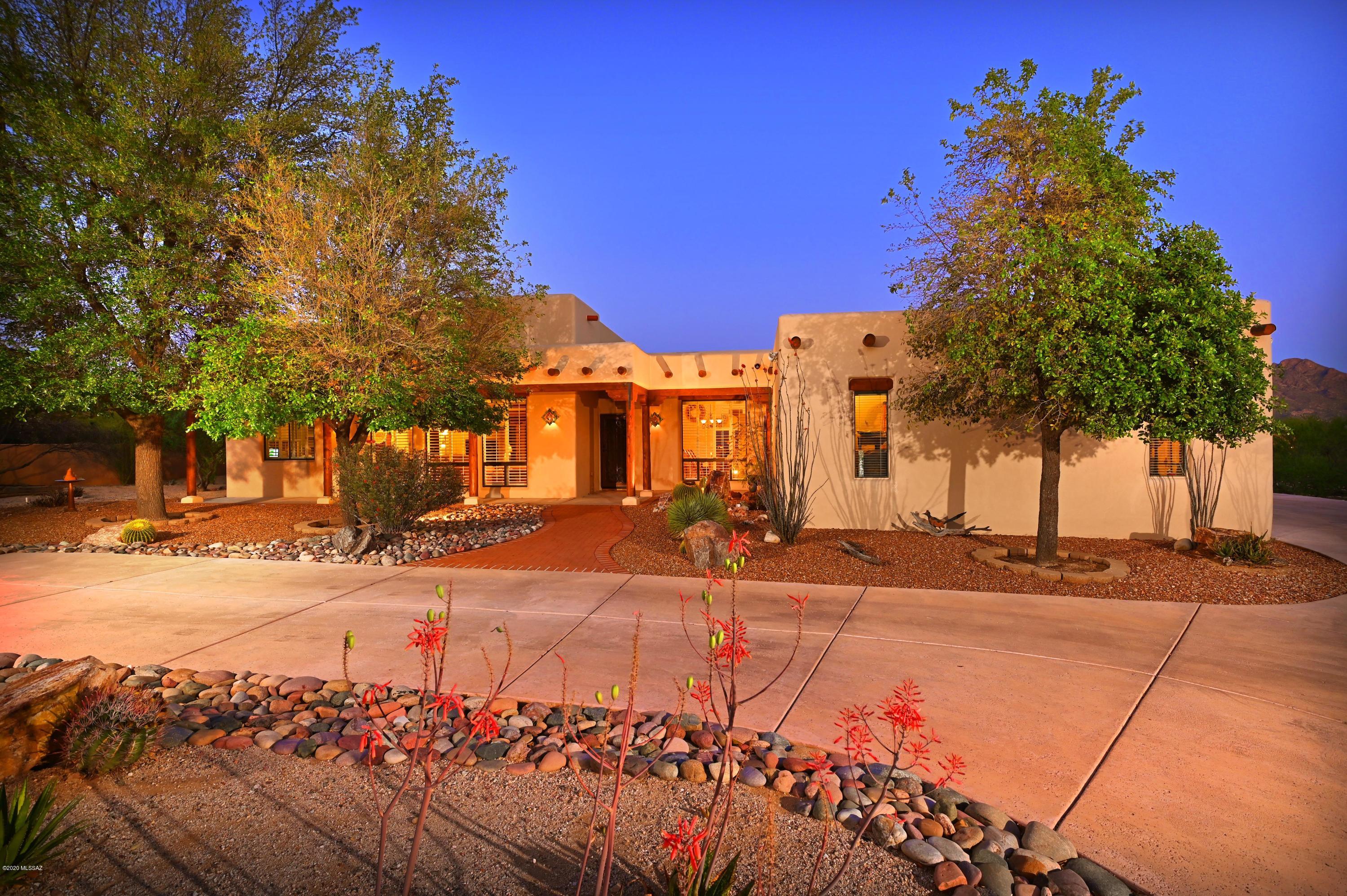Amazing premium Sante Fe style home for sale! Loaded with luxury plus some of the best mountain views in Arizona make this home a must see! Inside this home has it all. A Chef's kitchen provides thick cut granite slab counters, upgraded SS appliances, lots of prep area, oversized custom alder cabinetry with an eat in kitchen looking out to the mountains. A split bedroom plan provides privacy and space. Custom southwestern flair make this a true Sante Fe. Highly polished Mexican tile, high ceilings supported by rough cut beams and posts trimmed out in tongue and groove ceiling at living makes this an amazing property hard to duplicate for the pricing. 

Outside is an Arizona paradise. Supersized lot in the middle of upscale Oro Valley is a rare find. Pool, Patios, Privacy start here!