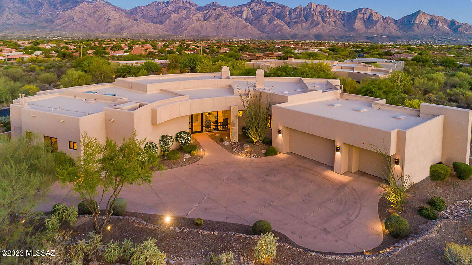 Panoramic Catalina Mountain views! Award winning architect, Kevin Howard designed 3BD/4BA/Den/Media Room (4,256 sq ft) estate on an elevated acre lot, with city light views, in the private, guard gated Estates at Honey Bee Ridge.  This resort-style home, w/ rare to find craftmanship throughout offers great room w/ fireplace, guest bedrooms w/ private baths, travertine floors, 900 bottle wine cellar, spacious laundry room, private office, media room and views in every room.   Chef's kitchen w/ dual islands, SubZero fridge, granite counters, 2 D/W, 2 ovens & 6-burner gas cooktop.  Spacious owner's suite w/ fireplace, luxury bath & custom closet.  Backyard oasis w/ expansive covered/uncovered patio, large grill island, saltwater pool w/raised spa, professional landscaping & views! A must see