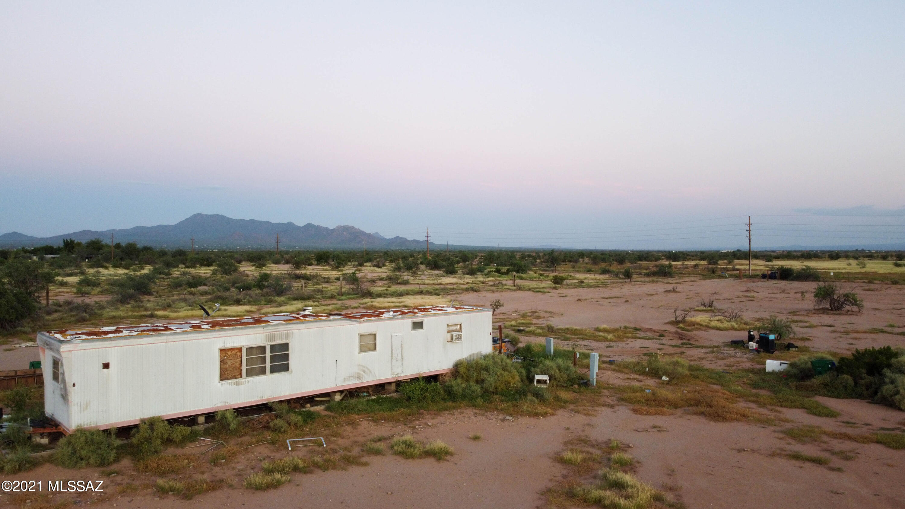 5 Acres of flat and level homesite that includes electricity, well, and septic that is perfect for your dream home on the range. Very rural, lots of privacy, this home site sits back deep into its acreage for peace and enjoyment . The lot is huge and has plenty of room for toys and animals. This is rural living at its best! Come see it today and make it yours! Mobile home on property is not a manufactured home and it conveys as is. Owner is a licensed agent.