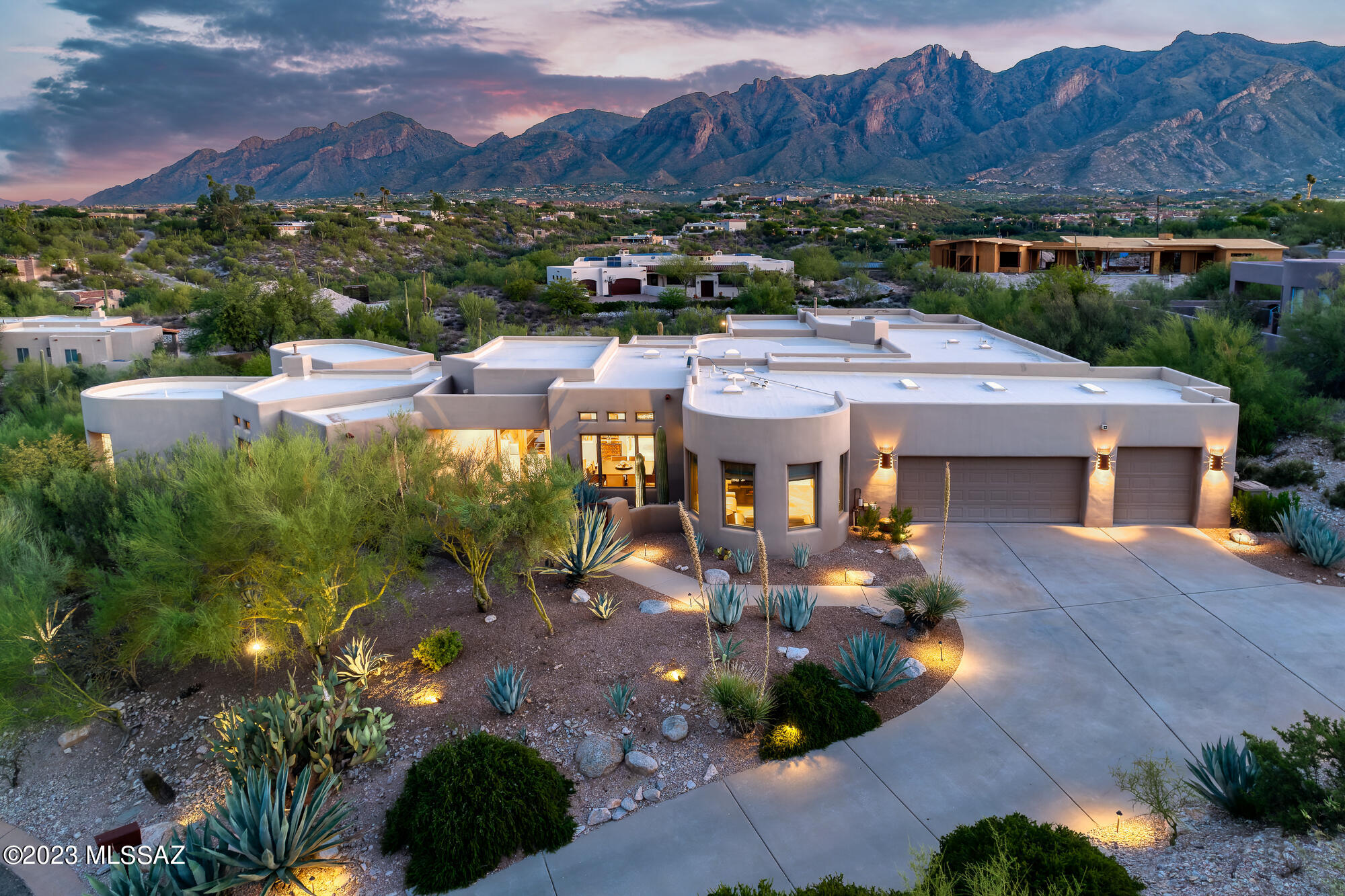 Impressive views of the Catalina mountains abound in this Ron Robinette-designed home in the gated Colonia del Sol neighborhood. Sited perfectly on a cul de sac lot with a 3-car garage, and situated atop a gentle rise, this lot offers the advantage of being elevated, providing unobstructed views of the surrounding mountains, the city lights, and mesmerizing desert sunsets, as well as supreme privacy. The property's courtyard entry is a picturesque introduction to this custom desert oasis. It offers a private and inviting atmosphere that sets the tone for the entire home.  The main home boasts six spacious bedrooms, plus an office, providing ample space for a large family or plenty of guests. Each bedroom is generously sized and features private access to a bath (5 ensuites and ... 1 jack and jill"). The split bedroom plan is thoughtfully designed for comfort and privacy. The separate casita is perfect for extended family, guest quarters, a large private office, or its current use as a yoga retreat. It features a full bathroom, a versatile Murphy bed, and a kitchenette for added convenience. The chef's kitchen in the main home is a masterpiece with high-end appliances, granite countertops, and a large, eat-in center island. The inviting dining nook and ample family room with fireplace are adjacent to the kitchen, creating an inviting great room space for everyday living. Additionally, there is a large formal dining area and living area with a wall of windows looking toward the Catalinas.  Step outside to your resort-like backyard with multiple patio areas, an outdoor kitchen, and a swimming pool and spa that have recently been redone with new PebbleTec and tile. Just a short distance from the historic Hacienda Del Sol resort, La Encantada outdoor shopping mall, La Paloma Country Club, and many popular hiking trails.