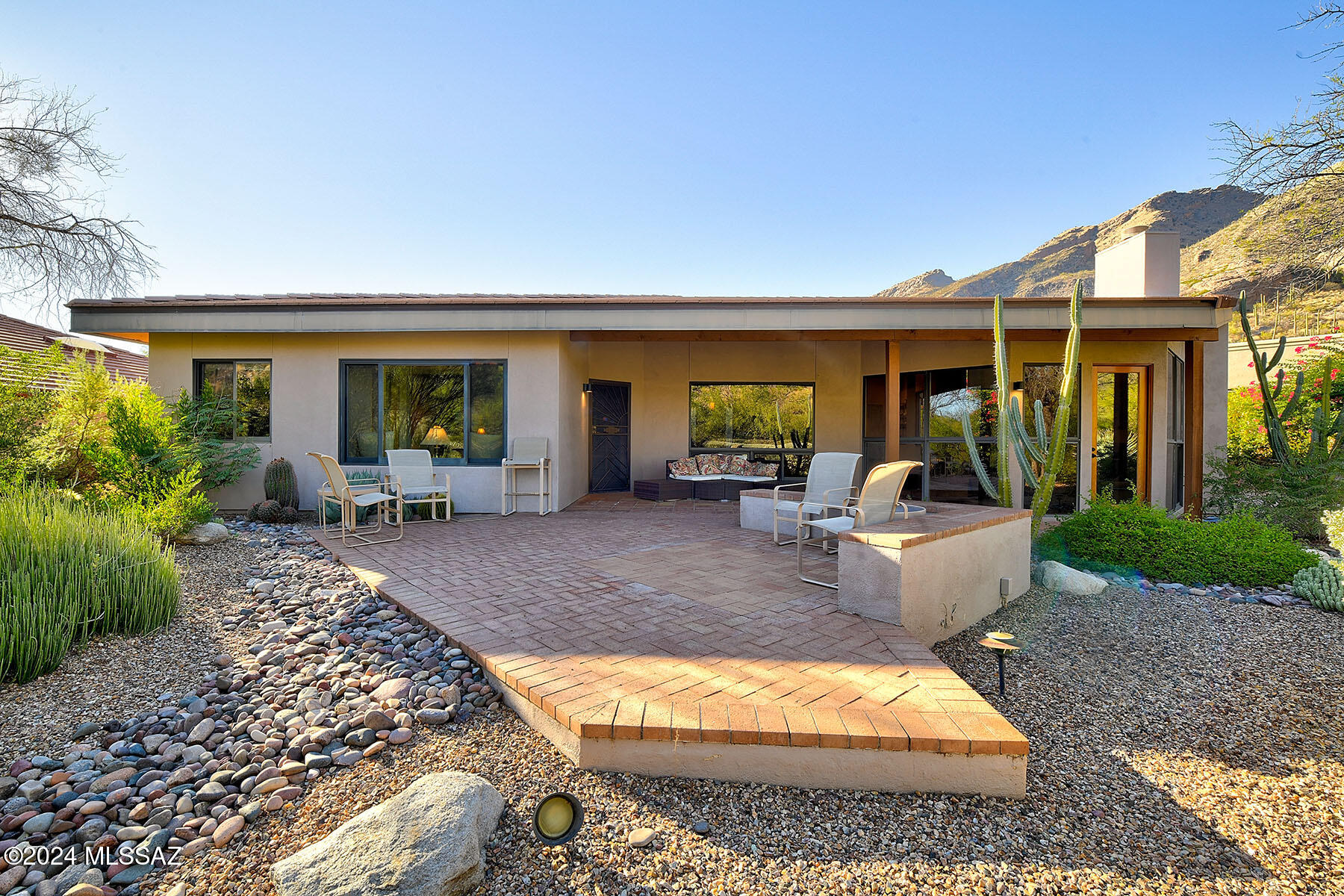Nestled within the serene Catalina Foothills, this captivating 2,494 sq ft Finisterra 3br/3ba 1 story home offers a blend of luxury & nature. Elegant solid wood front door opens into a light-filled space with Saltillo tile floors & high ceilings. Gourmet kitchen, features KitchenAid Superba ovens, Thermador cooktop, wood-clad Monogram refrigerator, quartz countertops, & custom wood cabinetry. Enjoy breakfast with breathtaking mountain views in the sunny nook or host elegant dinners in the formal dining room, complete with thoughtfully crafted built-ins. Step into the living room, where a gas fireplace & expansive floor to ceiling windows seamlessly blend indoor & outdoor living. Bedrooms offer ample space for king-size beds, each with dedicated full bathrooms. SEE MORE TAB One of the bedrooms doubles as a home office or exercise room. Primary suite is a tranquil retreat, with an inviting seating nook & separate office area framed by scenic mountain views.  Primary bathroom's dual quartz vanities, spacious walk-in closet, & walk-in shower flow seamlessly. Oversized laundry room, offers cabinets, two closets, & folding area. Large garage includes a storage closet with built-in shelving for all your essentials. Outside is a private garden oasis filled with beautiful vegetation & superb mountain views from several entertaining areas. Sought after man gated neighborhood in District 16 schools offers clubhouse, pool, spa, pickleball & tennis courts. Discover your dream lifestyle in this enchanting foothills haven!