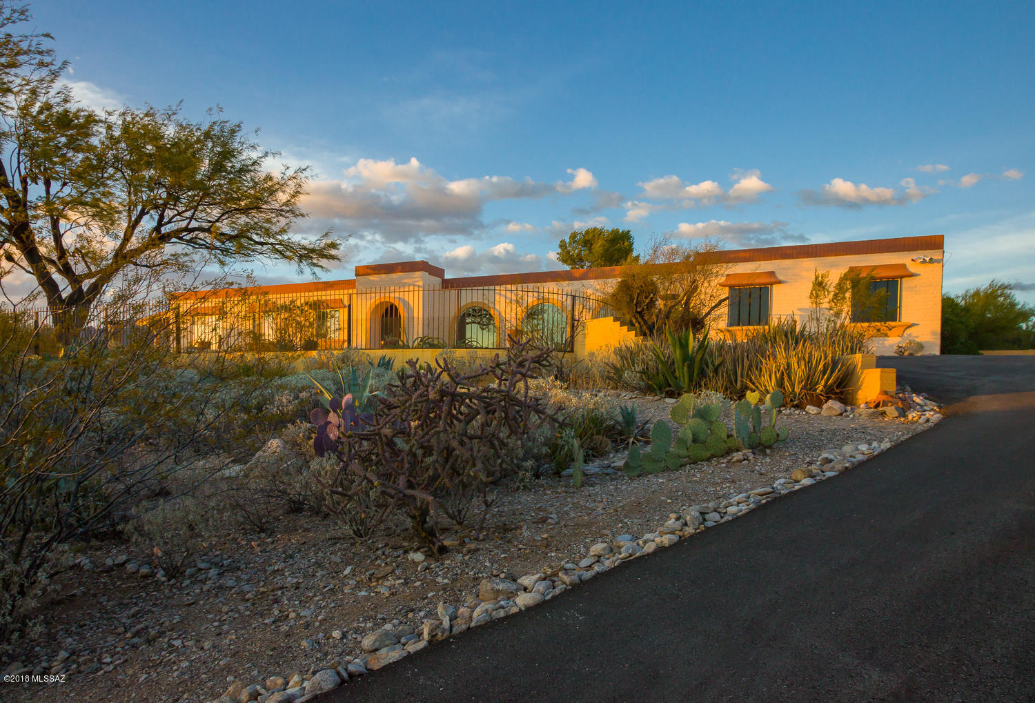 Exceptional views in desirable Catalina Foothills location! The well maintained home sits 2 stories above homes to the E, S & W to enjoy unobstructed views of the Rincon, Santa Rita, Tucson, Catalina Mts & Kitt Peak. The expansive view includes year-round sunrises, sunsets,& sparkling nighttime city lights. The pool & multiple patios are perfect for entertaining. Xeriscape desert landscaping includes an exceptional variety of low care plantings. Inside, mountain & city views are framed by generous updated windows from every room. Open floor plan kitchen with maple & alder cabinets, SS appliances, butcher block island, farmhouse sink & quartz counter-tops. Master bedroom en-suite bath has natural stone & polished granite with walk-in double shower, soaking tub, vessel sink & walk-in closet. Enjoy the cozy wood burning beehive fireplace on cool desert nights. Large laundry room with California Closets pantry offers additional storage space. A three-car garage plus large storage room is a huge plus at this four bedroom home.  Xeriscape desert landscaping includes an exceptional pine & mesquite tree, as well as saguaros, creosote, ocotillo, cactus, & agave to provide a natural Sonoran Desert habitat for native flora & fauna. So much to see and love at this stunning ridge top home! See it today!