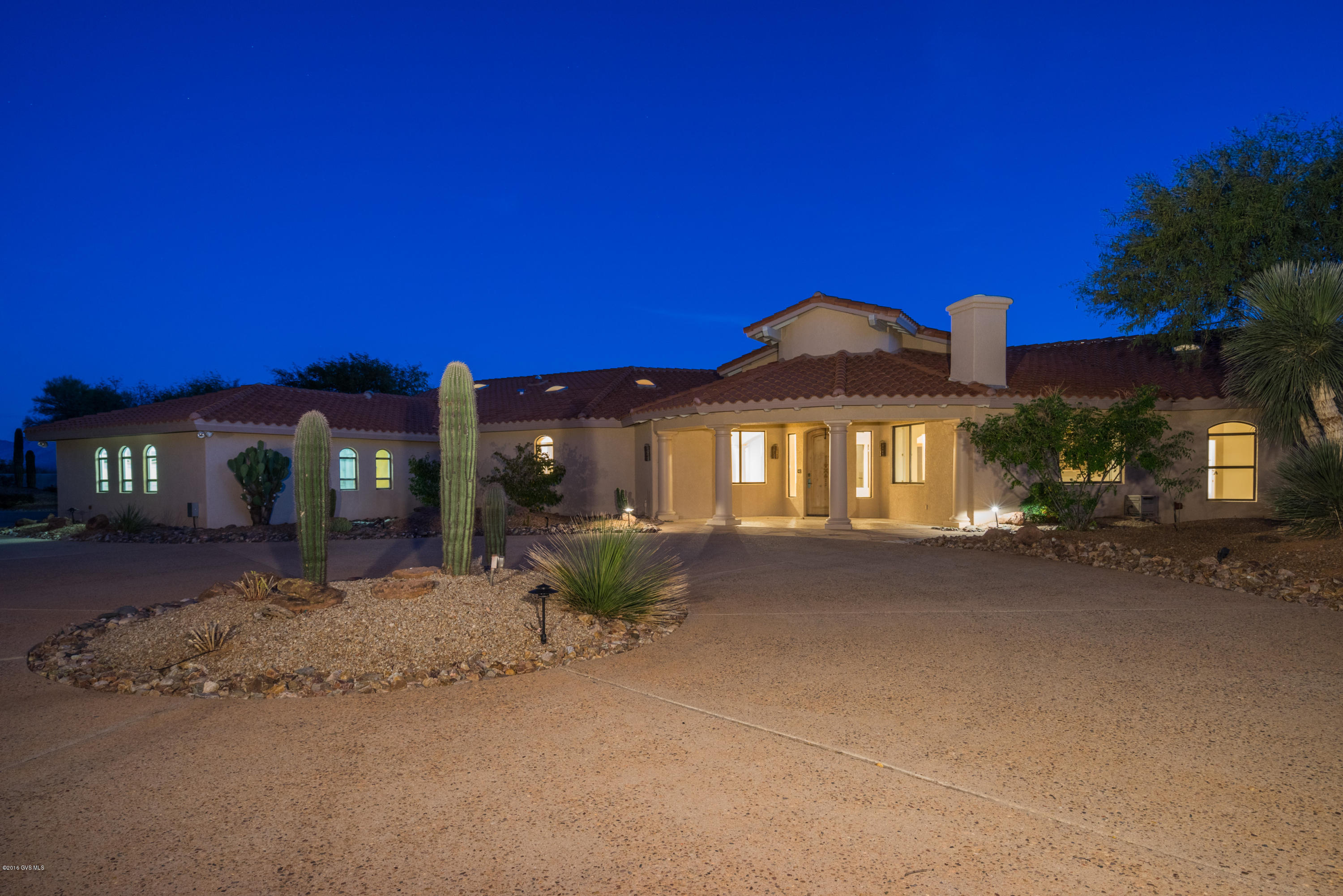 Mediterannean design is the inspiration for this incredible gated estate in the heart of Green Valley! Almost three acres with Santa Rita Mountain Views from every room! 5400 sq ft of luxury is comprised of 6 bedrooms, 7 baths, a pool house and a seperate guest casita. Lush desert landscaping and a circular drive frame the grand entry. Floor to ceiling windows with breathtaking views of the mountains greet you upon entering this spectacular home. The palatial great room showcases soaring wooden beamed ceilings, an entertainment bar, a roaring fireplace, seperate gaming area, and elegant dining room. The gourmet kitchen is nothing short of amazing with its sub zero fridge, granite counters, seperate ice maker, gas cooktop and VIEWS of the mountains everywhere you turn. A spacious den  is conveniently located off of the great room and boasts its own fireplace. 2 more bedrooms with ensuites graciously accommodate your growing family or all of your winter visitors! The master suite is an opulent retreat with its grand space, awe-inspiring views and spa-like bath. Stepping outside is an unforgettable experience in this home! An expansive patio overlooking the pool and mountains is the perfect setting for family, friends and memorable events. A pool house and seperate guest casita add to the welcoming ambience. If your dream is a magnificently impressive home in a completelty private and tranquil setting, then "Welcome home"!