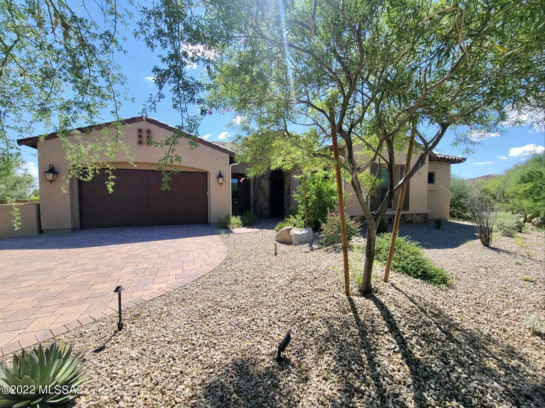 Tucked behind the gates of the sought after Stone Canyon community, this stunning home feels and lives  like new.  Built in 2019, featuring two master bedrooms each with massive closets and large sophisticated bathrooms. Expansive windows and large sliders provide ample natural light throughout while showcasing the beautiful desert landscaping. This 3 bedroom/ 3.5 bath home is perfect for a secondary home or full time residence.  This functional design offers an open concept great room and kitchen with stylish finishes throughout.  
Stone Canyon is ranked among one of the best golf courses in Arizona with a gorgeous Clubhouse and state-of-the-art Health and Fitness Club.  Set within the town of Oro Valley, you will love the convenience of having every amenity you can think of nearby!
