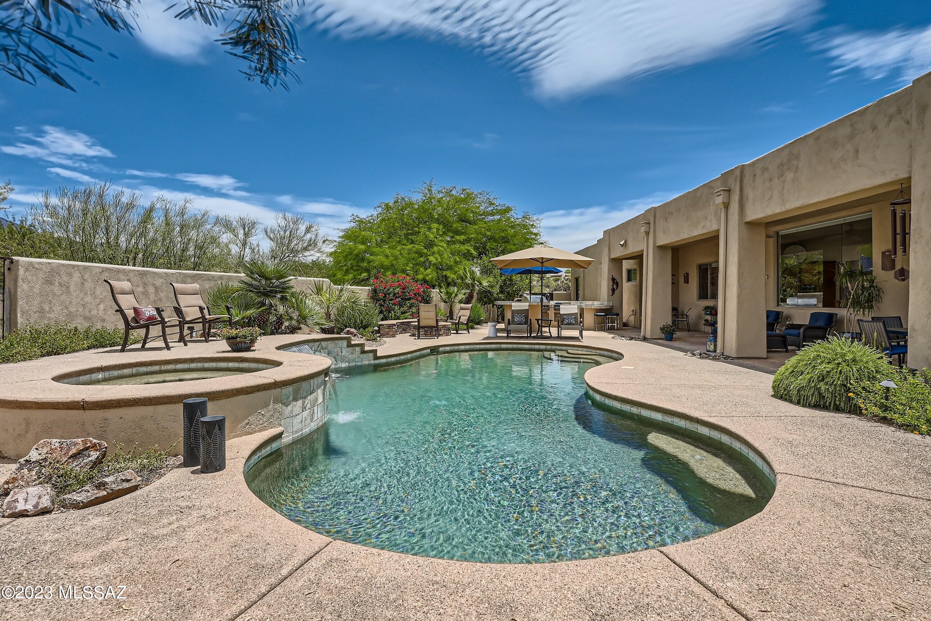 Introducing Corte Vista Montanosa, a stunning single story Catalina Foothills oasis tucked away in a secluded five home gated community. Offering a harmonious blend of luxury, unrivaled privacy and breathtaking mountain views this home is nestled on a .84 acre cul-de-sac lot. 

Approaching the front courtyard you will be captivated by the lush mesquite trees, desert plants, filtered morning light and colorful evening sunsets. The heart of the home is immediately apparent upon entering. A grand foyer sets the tone for the rest of the residence and offers a seamless flow to the thoughtfully designed living spaces. An abundance of natural light, high ceilings, and a generous wall of windows provides a sense of spaciousness while capturing the breathtaking beauty of the Catalina Mountains. For those that appreciate culinary excellence, the gourmet kitchen is equipped with Viking Professional appliances, granite counters, a prep island and abundance of storage. Whether you are preparing a casual weeknight meal or entertaining with family and friends, experience the fluidity and ease of movement that this beautiful kitchen offers. 

With five nicely appointed bedrooms, there is a generous amount of space for family, guests, an office or even an in-home gym. The primary bedroom is a true retreat, complete with a private ensuite bathroom, double closets, walk-in shower, soothing jetted tub, and a serene atmosphere that invites relaxation.  However, the true beauty of this property lies in its unparalleled resort-like outdoor spaces! On warm summer days escape from the demands of everyday life and take a refreshing dip in the pebble tech pool or lounge on the sun soaked pool deck. For the outdoor enthusiast or avid entertainer, the expansive outdoor kitchen is a chef's paradise. Dine al fresco under the spacious covered flagstone patio and as the sun sets, gather around the fire pit, cozy up by the outdoor fireplace or relax in the spa while watching the beautiful shades of pink and orange dance along the tops of the Catalina Mountains. 

Experience all the conveniences of the Catalina Foothills with easy access to shopping, dining, golf, paved paths for biking, walking and running, Sabino Canyon, Finger Rock and Ventana Canyon for hiking, Tucson Medical Center and renowned schools. This location offers endless possibilities to enjoy desert beauty and the vibrant Tucson lifestyle!