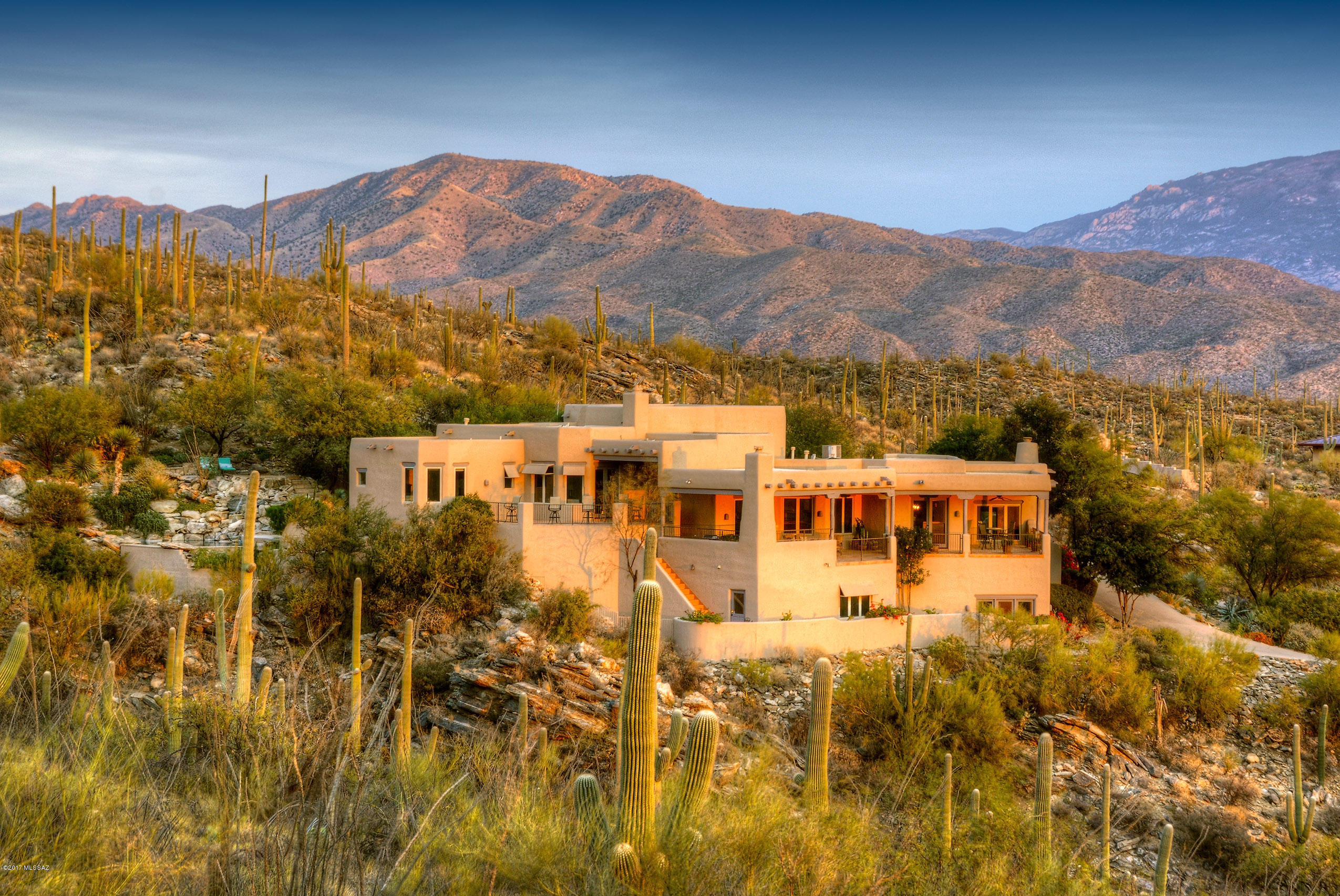 Absolutely Breathtaking Mountain & City Light Views from this Authentic & Awe-inspiring Santa Fe home built by the renowned builder, Ray Birch, & nestled at the base of the National forest on 4 pristine acres. This spectacular home offers casual elegance w/gorgeous wood beamed ceils, Venetian plaster walls, Huge open island kitchen w/SS appl, Multiple FPs & a wonderful spacious flrpln that’s perfect for entertaining. Outside, you are truly communing w/nature from the very private waterfall, spa & pool w/swimming jets, to the multiple verandas, viewing decks & the blt-in BBQ area w/FP & banco seating.  Luxurious Mstr Ste offers a spa-like bath w/dbl sinks, garden tub & private deck. Plenty of room for friends & family in the guest casita, game/hobby rm. Your own secluded sanctuary awaits!