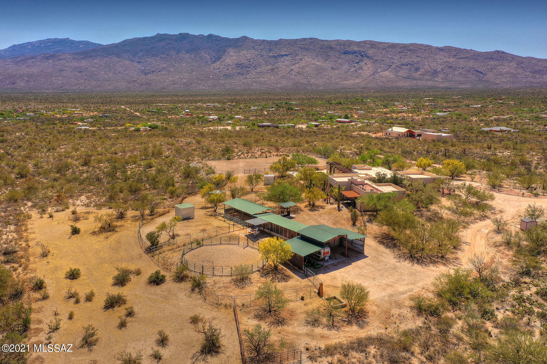Stunning property located near Saguaro National Park East. This Equestrian style property on just under 10 acres was designed by renowned Architect, Bennie Gonzales, w/notable designs such as the Heard Museum, and over 131 architectural awards. It is nestled high affording majestic views of the Mountains. This 5 bedroom home offers separate wing w/family room, office, 3 bedrooms, 2 baths & laundry. A stunning living room w/walls of windows afford Mountain views. Kitchen features Mesquite custom cabinets, honed black granite & brick accent wall. Large Master Suite w/custom Mesquite doors & private patio reside in main wing w/additional bedroom & bath. Horse facilities include stables, tack room, Dressage arena, hay storage, 1/2 bath & large open barn for storage of equipment. Very Special!