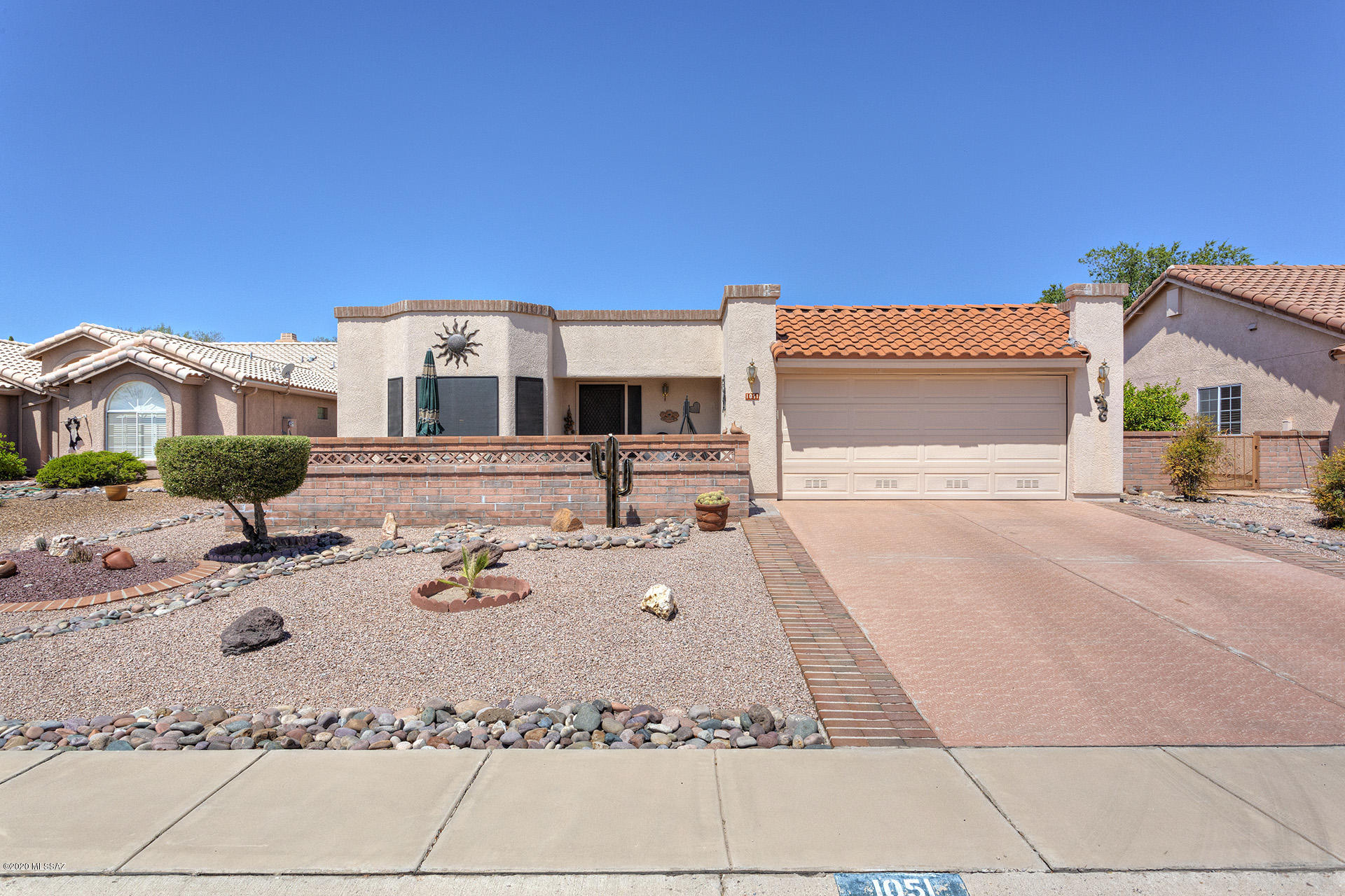GORGEOUS INSIDE AND OUT fully furnished with,very nice furnishings, Dorn built home.  Shows like a model.  Home  originally a model home.   Epoxy coated drive.  Lovely courtyard nicely finished with pavers and wall for privacy.  Enjoy beautiful Santa Rita Mountain views and  gorgeous sunrises. Home is spotless and well maintained. Freezer in garage stays.  AZ room is tiled. Beautiful sliding windows with screens to enjoy gentle breezes. Has own AC unit.  Included  very nice, like new hot tub.  Large very private back yard.  Termite warranty from Bill's Home Service.  Roof  coated 2019, water heater 2018,  washer/dryer 2019.  New carpet.  Home gently used only 2 months each year for last 10 years. NO GVR, but is available.   DON'T MISS OUT ON THIS VERY SPECIAL HOME!  COME FALL IN LOVE!