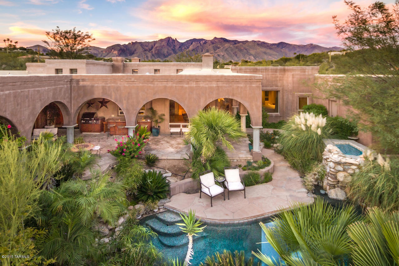 Amazing Privacy & Seclusion! Incredible Detail Throughout w/Stunning Mountain and City Views! This All Masonry Home Features Solid Wood Doors, 5 Fireplaces & Unique Custom Ceilings throughout. Kitchen Boasts a Brick Ceiling, Granite Counters, Handmade Cabinets and Pizza Oven! Spacious Master Suite w/Fireplace, His & Hers Separate Bathrooms, Steam Shower & Private Access to Back Patios & Spa. Lush Oasis Backyard Features Granite Wet Bar/Grill  Area with Sink, Negative Edge Pool and Hot Tub. Guest House has Private Walkway and Private Yard. Gated Driveway. Oversize 3 Car Garage w/Storage. Built By Master Builder Howard Curtain & Was His Personal Residence for 8 Years.