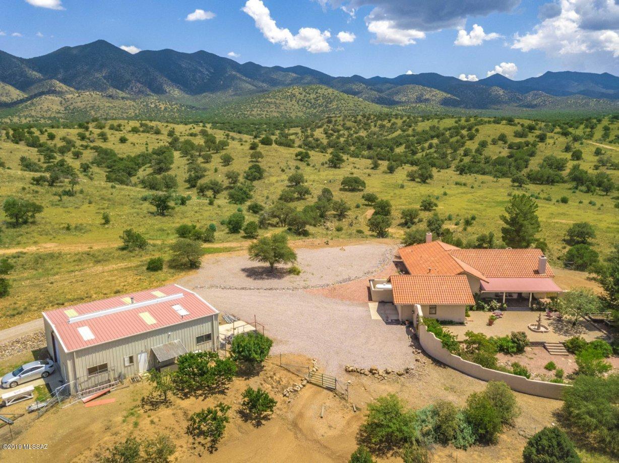 Majestic and Beautiful is the best way to describe this masterpiece of a home. Situated on 44 pristine acres nestled up against the Huachuca National Forest. This rammed earth home is totally custom from top to bottom. Baltic birch cabinets with solid walnut tongue and groove drawers with European hardware, Fir Colorado vaulted beams in the living room, Antique Mexican interior doors, 700 bottle wine room, subzero fridge, Miele oven, Kitchen aide dishwasher, walk in pantry, Mexican roof tiles, 18'' Saltillo floors, custom Mexican tile in bathrooms. Snuggle up in the master, living room, or patio enjoying the beehives fireplaces. Horse facilities for the equine enthusiasts. Whatever your hobby is enjoy the 2000 sq ft shop with guest facilities inside. Custom dining room chandelier to light up any dinner party. Don't miss this rare opportunity to own the home of your dreams.