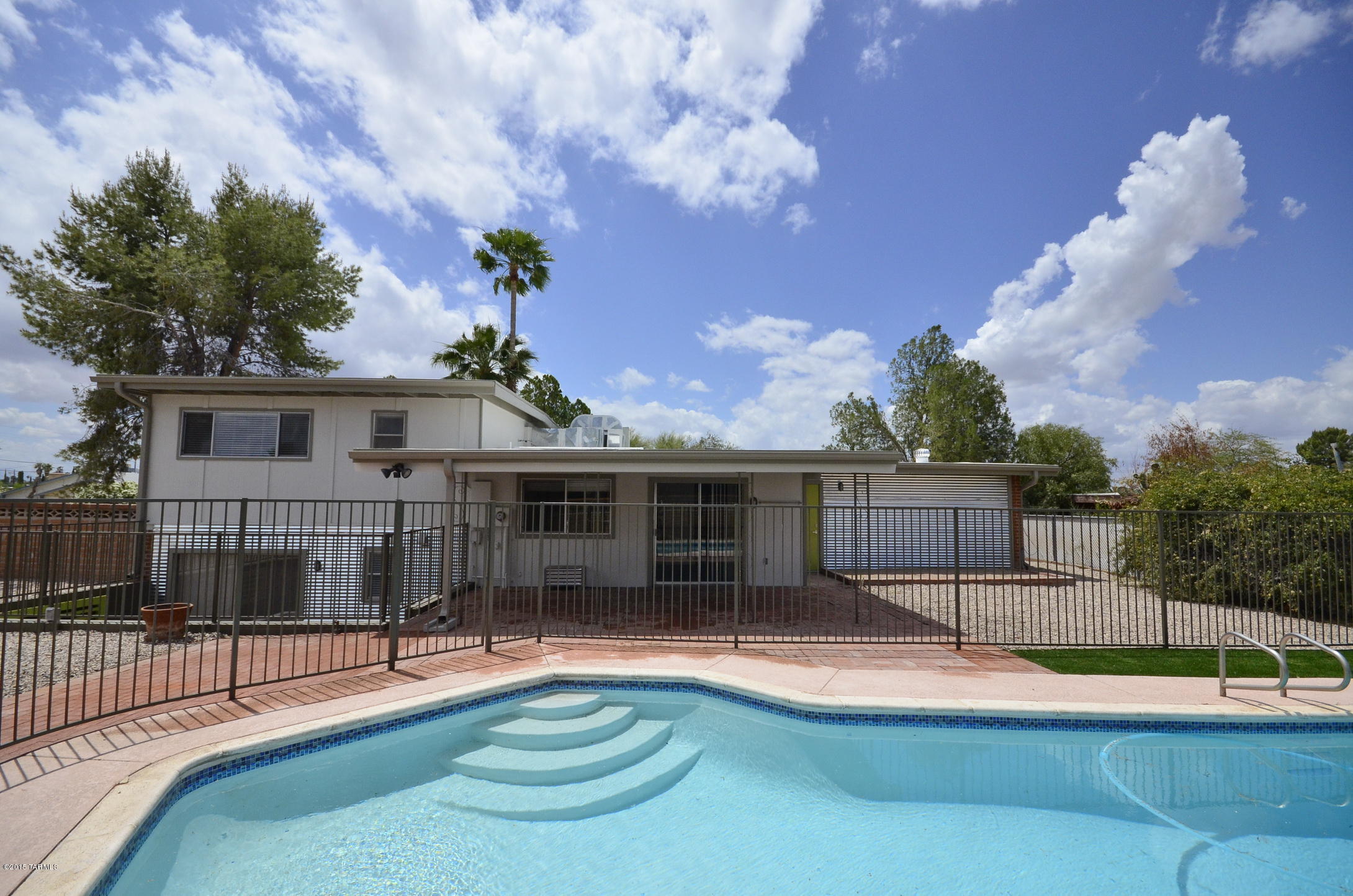 NO FEE to APPLY!!  
STUNNING, 5/3, remodeled, east side tri-level home w/large backyard, pool & covered brick patio. Non-smoking.  NO carpet! Wood burning fireplace, dual paned windows, ceiling fans, WASHER & DRYER INCLUDED!  Gorgeous kitchen w/SS appliances, incl.  gas range.  Beautiful cabinets, countertops, sink & glass mosaic backsplash.  Bonus family room/office downstairs w/bath & patio. Fantastic, large fenced backyard w/pool, security fence, gravel & turf, covered  patio.  NO HOA!!  SPACE TO PARK A BOAT, TRAILER/RV, w/ electric hook-up!  2-car garage & low-care landscaping front/back. Close to schools, parks, shopping & restaurants.  Tenant responsible for pool service fee of $175/month. Sorry, no cats.  sec. deposit $1995.  Avail. 8/1.  Call Susan w/Aros Realty at 520-954-9232 Final step in the process is the $45 Background/Credit check fee.  NO fee to submit an application.