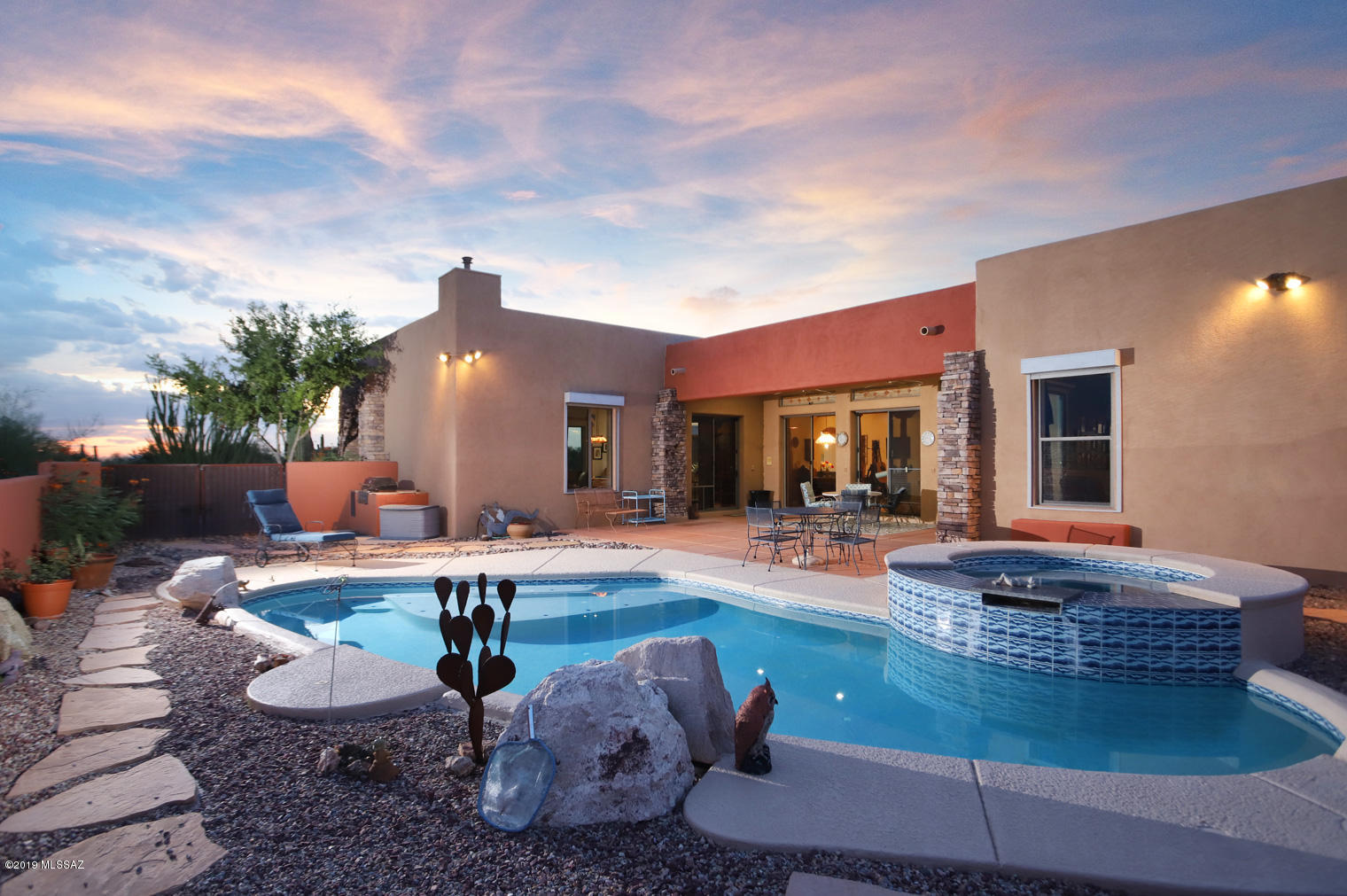 Picturesque, mountain and sunset views frame this stunning block stucco custom home nestled on a private 3.3 acre lot. This amazing 5 bedroom, 4 bath, dream home features spacious open floor plan, high ceilings, beautiful  tile floors. Gourmet island kitchen w/SS appliances, custom cabinetry and granite counters. 4 luxurious bathrooms. Spacious family room w/cozy fireplace. Studio/office perfect for guest quarters. Resort style outdoors w/sparkling pool and spa, covered patio, fireplace, beautiful landscaping, great views of Catalina and Tucson Mountains and sunset views! Solar Electric (PV) System (cost $39,000+/-). Average electric bills past 24 months $43 per month! See Custom Feature List, 3D Showcase, aerial video, floor plan & solar  info. Priced at only $168 sqft!