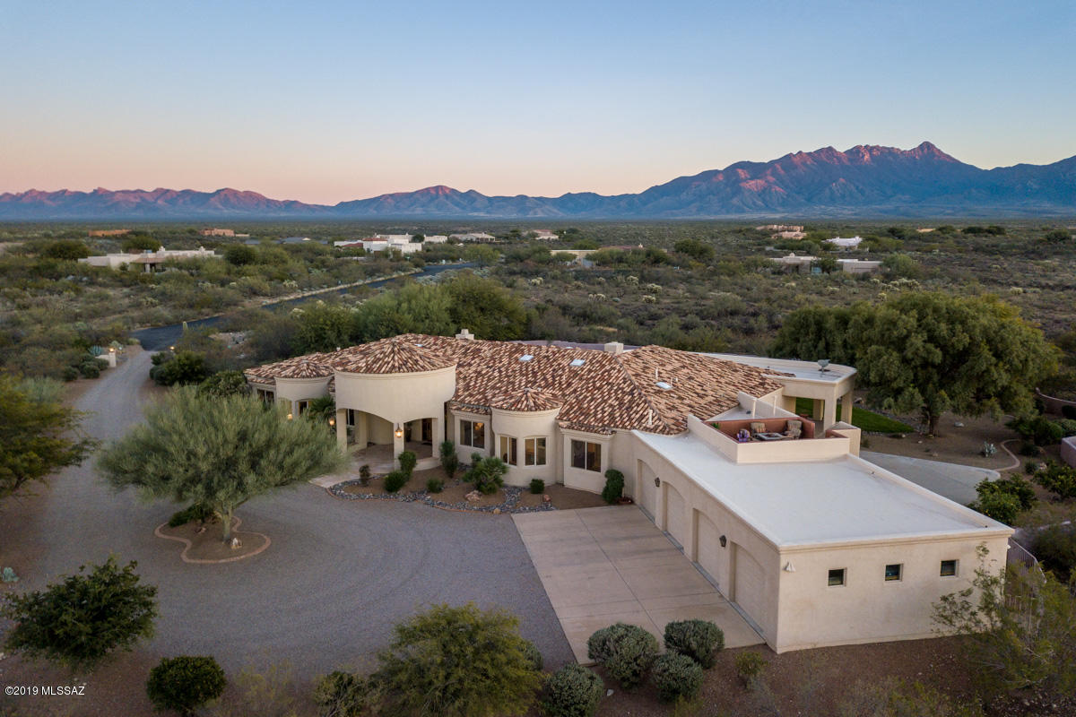 Live in absolute luxury with mountain views, a pool and spa, home theater, gourmet kitchen, putting green and 3+ acres of your own! This home has everything you have been dreaming of with nearby hiking and golf, a short drive from Tucson and Tubac. Enjoy sunrises and sunsets on your rooftop deck complete with a firepit for those chilly days in Arizona, entertain family and friends in the open kitchen with double ovens, convection oven, dual dishwashers and built in refrigerator. This home boasts 5700 sq feet with stunning mountain views out nearly every window and everything you need to start living your resort life!