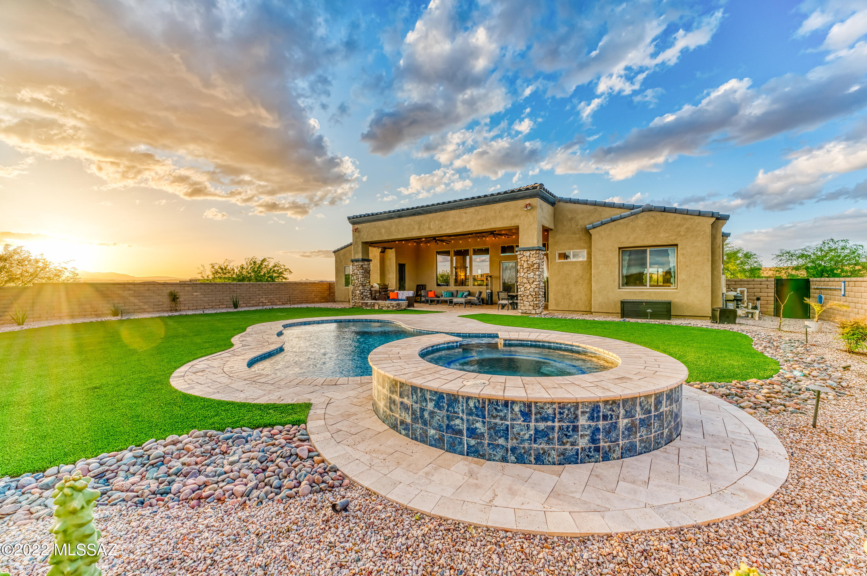 A rewarding escape, this 4 bedroom, 3.5 bathroom home with 3,282 sq feet rests on   .65 Acres . On a peaceful cult-de-sac in the serene, gated stone house neighborhood. Richly-appointed spaces includes large gathering areas, a bright, professional-grade kitchen with sub zero wolf appliances, which includes a custom built in wine fridge. The resort-like backyard includes a sparkling saltwater pool and spa with Fire pit and grill. The Large windows throughout the home invite you to daydream while staring out onto the beautiful cotton candy skies and the breathtaking Santa Rita mountains. The luxurious touches throughout the home will have you already moved in and planning your next big hosting event. This home has a list of upgrades with Hunter Douglas blinds, whole house water filtrations and reverses osmosis, and solar tubes.
Storage in garage And 14 ft ceilings .
The 3-car garage has room for multiple vehicles, so go ahead and bring your golf carts for a quick stop at the neighborhood quail creek restaurant!