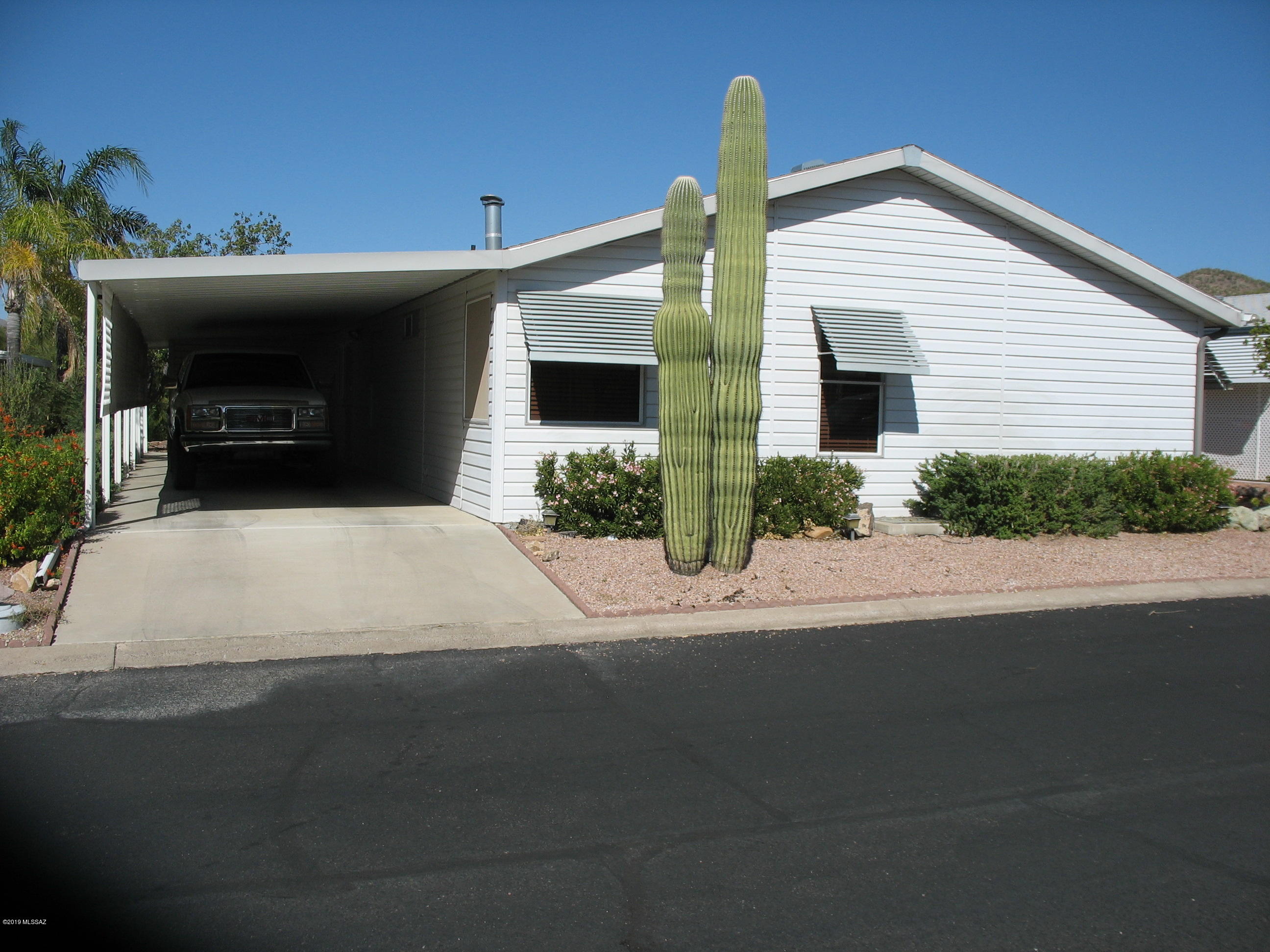 Very nice updated home with AZ room and backyard patio with awesome views!  This 1994 Cavco home has vaulted ceilings, gas log fireplace, and double door office/den room off living room.  Two walk-in closets in the master bedroom with wood blinds in the master bedroom.  Very nice Arizona room great for entertaining.  Private patio behind home with great mountain views across wide wash.  Copper Crest is a gated 55+ Active Adult Community which includes swimming, spa, shuffleboard, pool table, work-out facility, hiking and biking, and more. And, all within a short distance of Tucson.