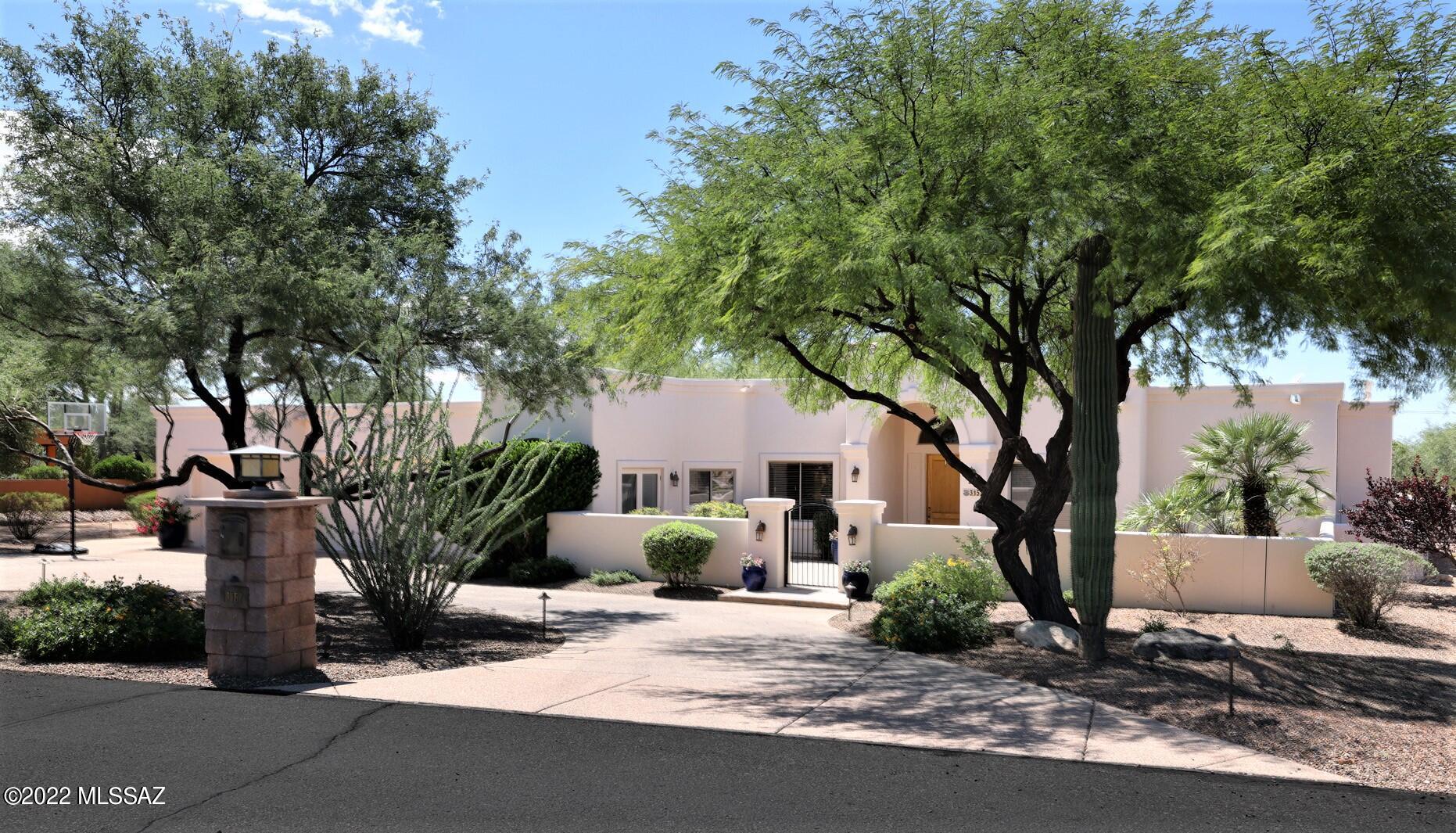Welcome home to this spectacular southwest contemporary with sky high ceilings, travertine tile in all the right places, fabulous split floorplan, deep 3-car garage and the most amazing backyard boasting sparkling pebble tec pool, spa, gorgeous lawn, sport court with BB hoop, inviting ramada with outdoor kitchen, beautiful mature vegetation including citrus trees all in the much sought after gated community of Madera Mesa.  Inside, the lovely kitchen with alder cabinets, granite countertops, dbl ovens and dining area will be sure to please any entertainer.  Primary Ste features dbl vanity, jetted tub, sep shower w/seat, walk-in closet & direct access to bkyd.  Other highlights include arches throughout, 3Br, 2Ba wing with study/office area and lovely fireplace in formal living room.