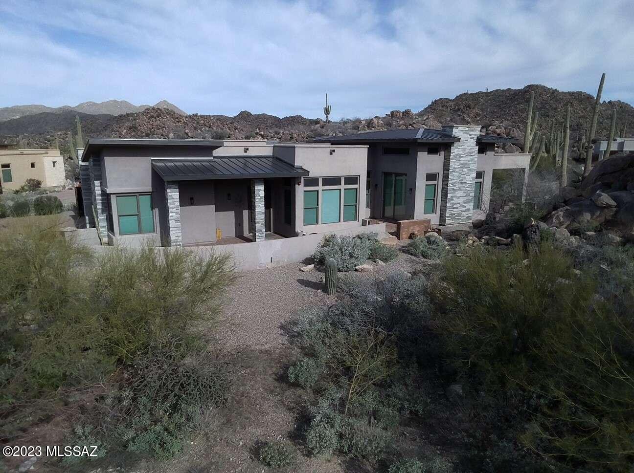 Southwest contemporary on a prime . 78 acre lot in Stone Canyon. Three ensuite bedroom plus powder room. Ceiling heights of 12-ft to 16-ft throughout. Ten-foot tall door-walls lead to each of three private patios. Views of Mt Lemmon from the dining patio. This gently used seasonal home was purchased new in 2019 and has been meticulously cared for.