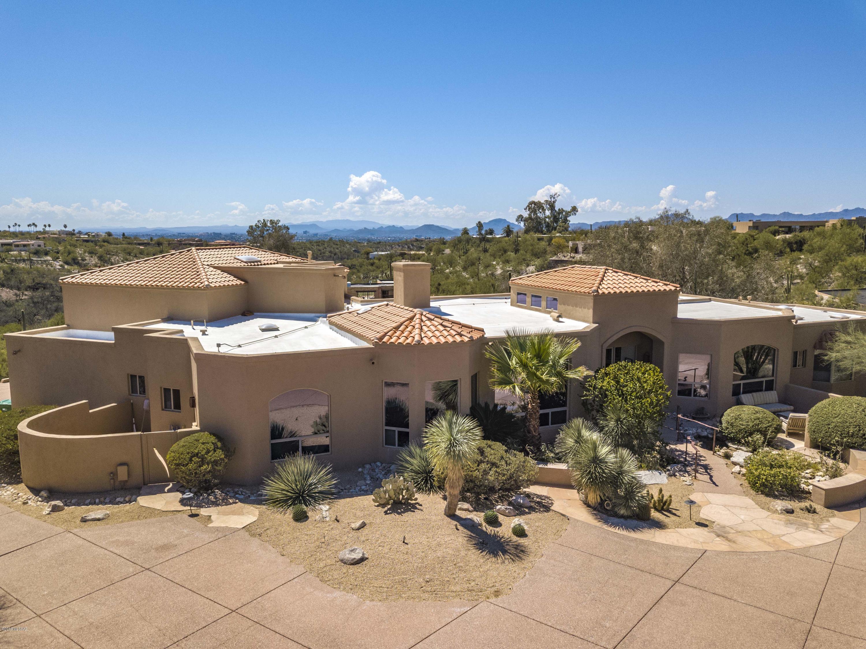 Rarely available Ultimate Foothills Lifestyle Home! This exceptional home in coveted, guard-gated La Paloma Estates has it all: panoramic mountain & city views, private lot, split floor plan, guest house - an entertainer's dream! Situated on one of the largest lots in La Paloma Estates on a cul-de-sac, with views of Hacienda del Sol Resort. Meticulously maintained. High-end features include Dacor & Subzero appliances, cedar and knotty alder doors throughout, 2500 bottle wine room, concrete floors, ICF/Rastra construction, 3 car garage, endless storage. Enormous first floor master retreat opens to covered patio. Tranquil backyard has gas fireplace, Pebbletec pool & spa, waterfall. Ride your golf cart to Country Club/Resort or step out south to access miles of hiking trails. Don't miss it!