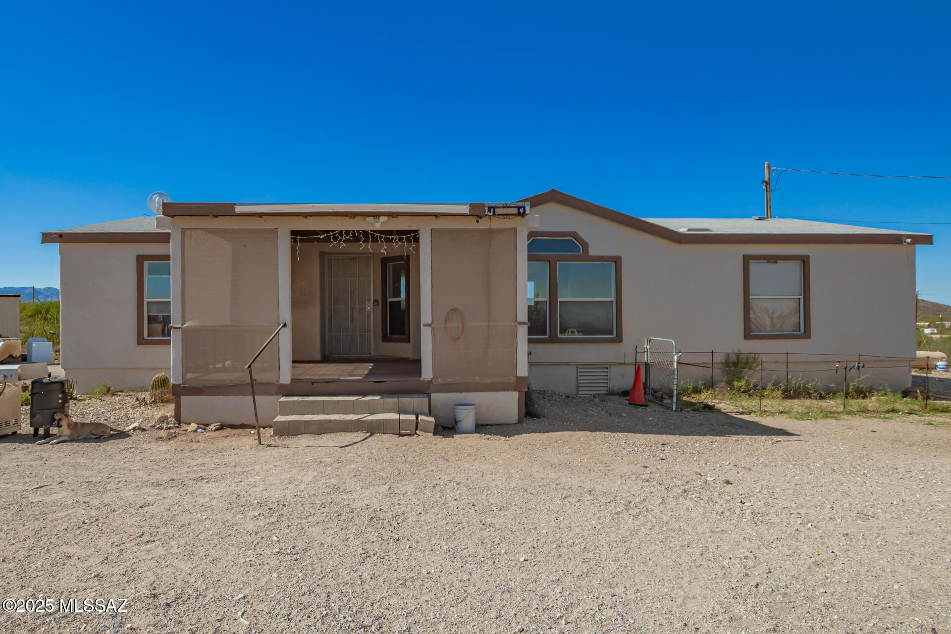 Set on 4.38 acres, this well-maintained manufactured home offers comfort, privacy, and beautiful desert views. A cozy front porch welcomes you into a light-filled living room with vaulted ceilings and a neutral palette. The eat-in kitchen features wood cabinetry, built-in appliances, ample counter space, and a breakfast bar island. The spacious main bedroom includes dual sinks, a soaking tub, a step-in shower, and a walk-in closet. Outside, enjoy natural desert landscaping plus a detached workshop/storage building. Peaceful living with endless possibilities!